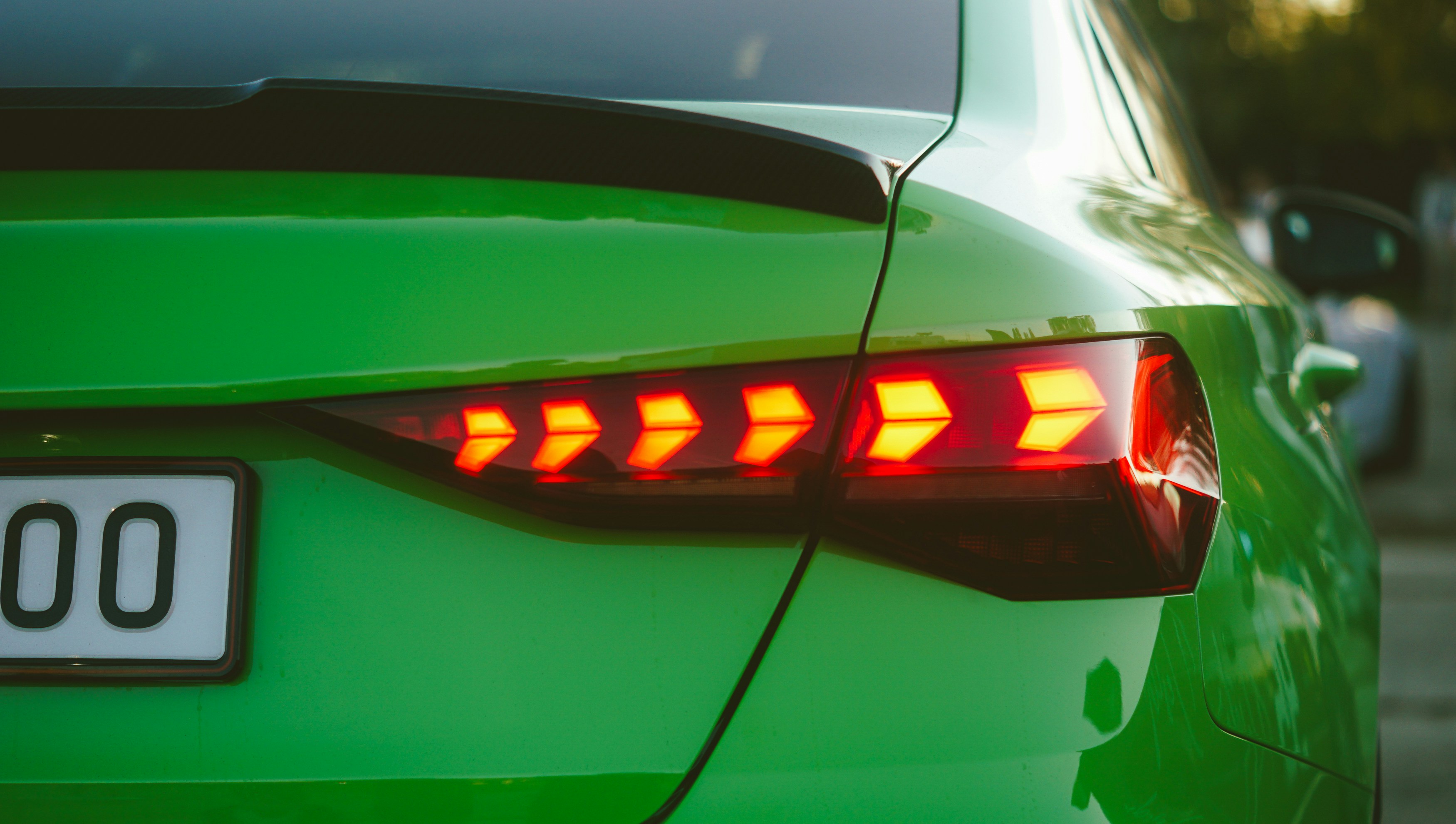 Close-up of a bright green car's taillight