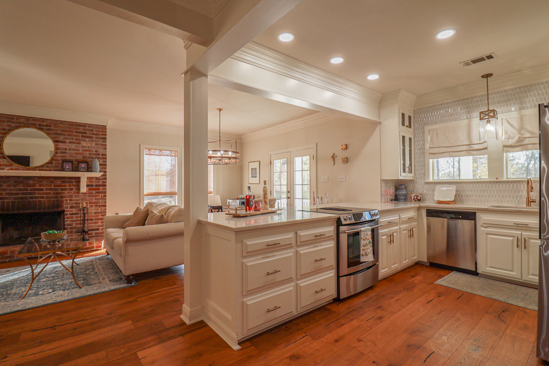 Modern kitchen with island and adjacent living room.