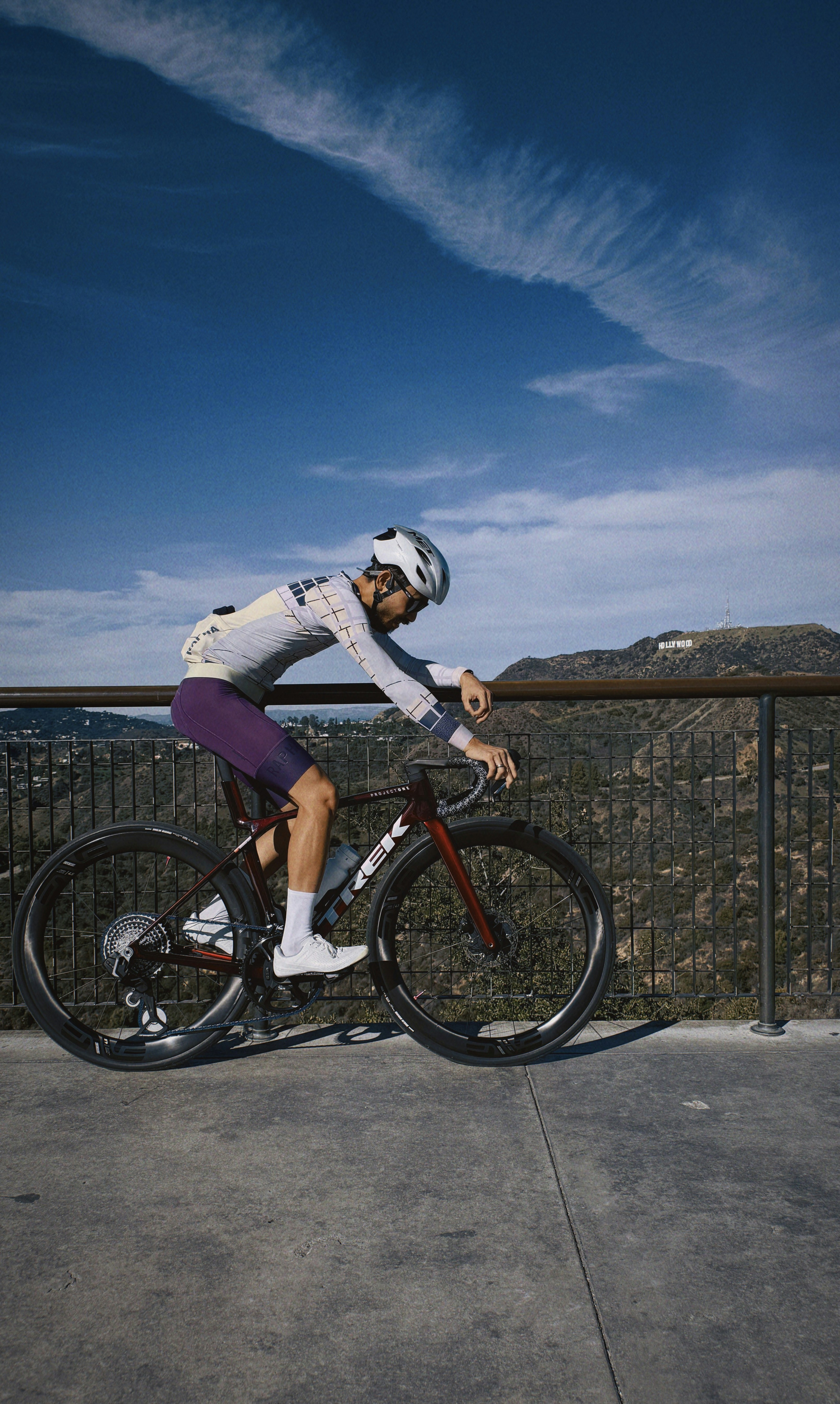 Cyclist in purple shorts on a bicycle overlooking hills