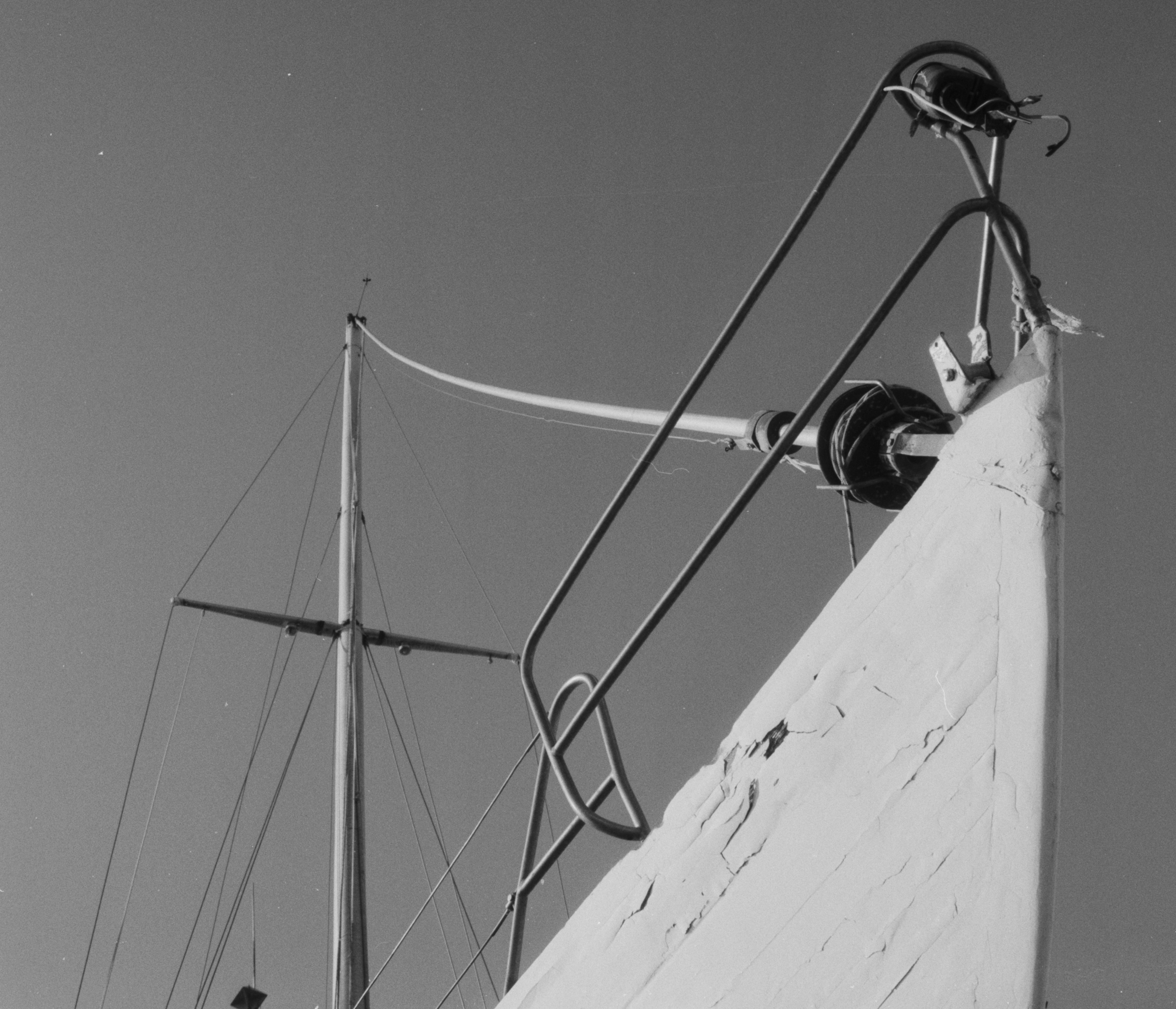 Sailboat mast and rigging against a clear sky