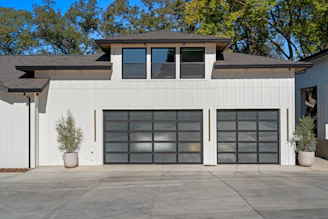 Modern garage doors on a white house