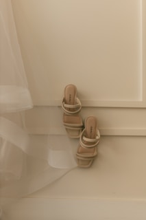 A pair of beige strappy heeled sandals