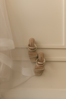A pair of beige strappy heeled sandals