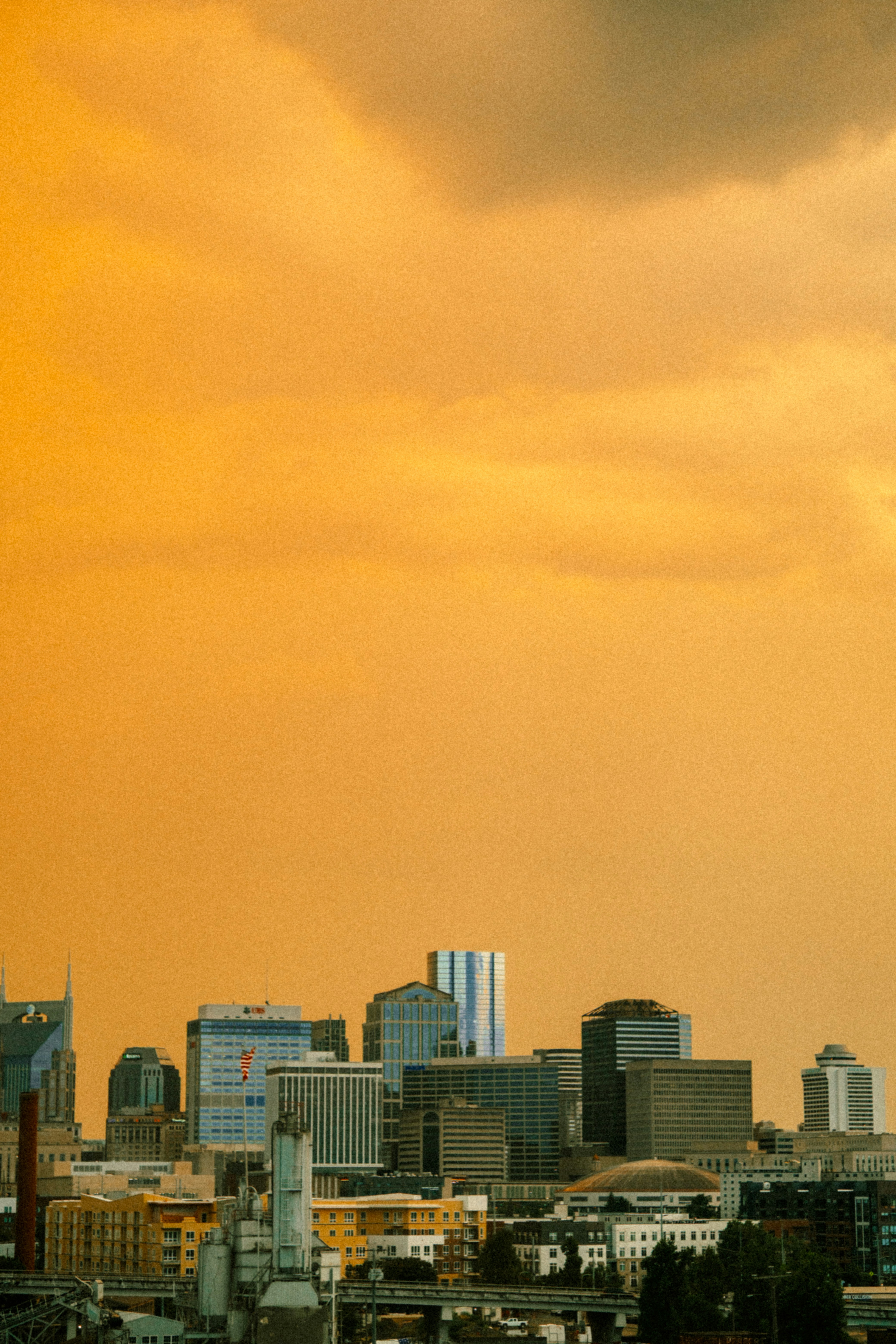 City skyline under a hazy orange sky