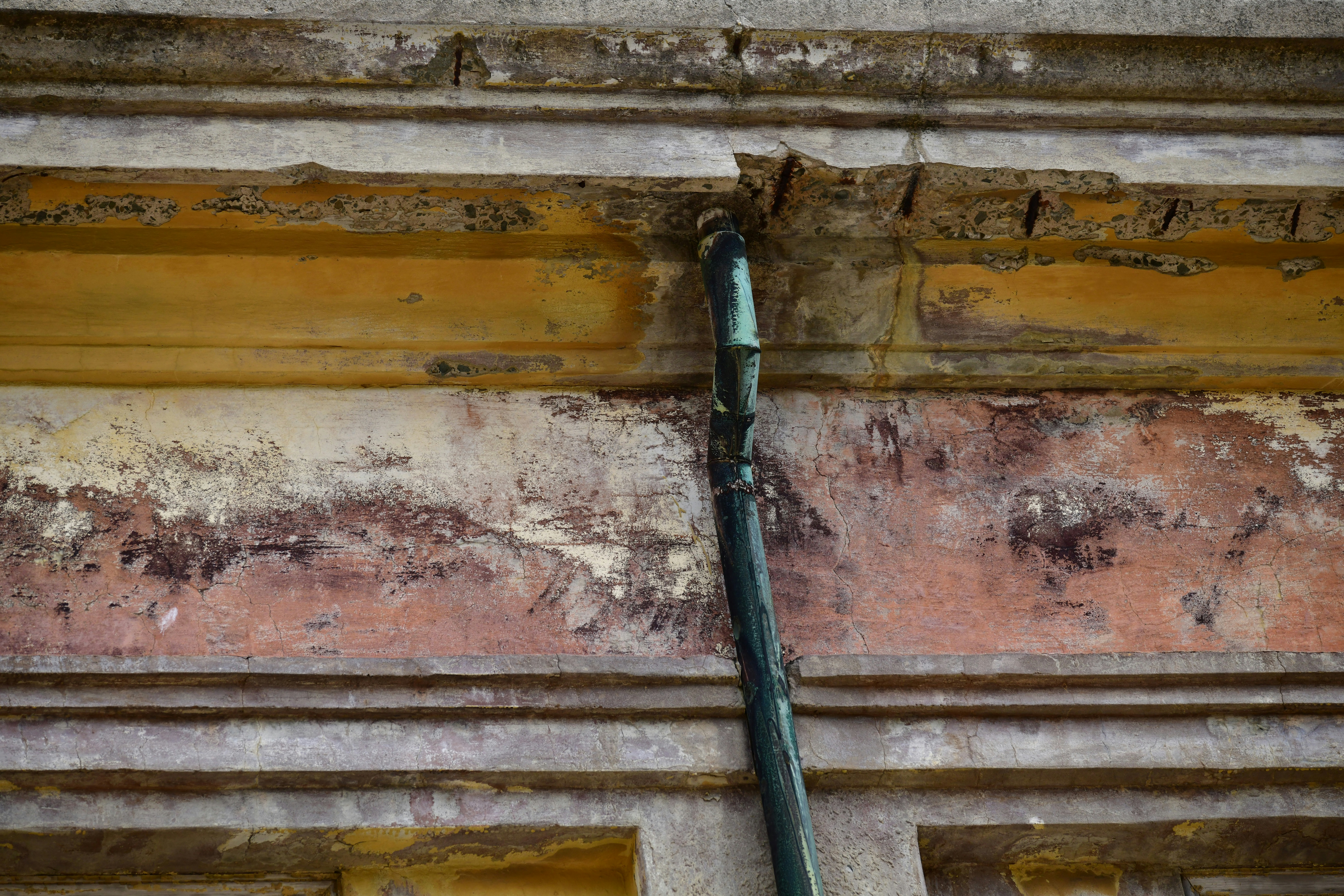 Close-up of peeling paint on an old building facade.