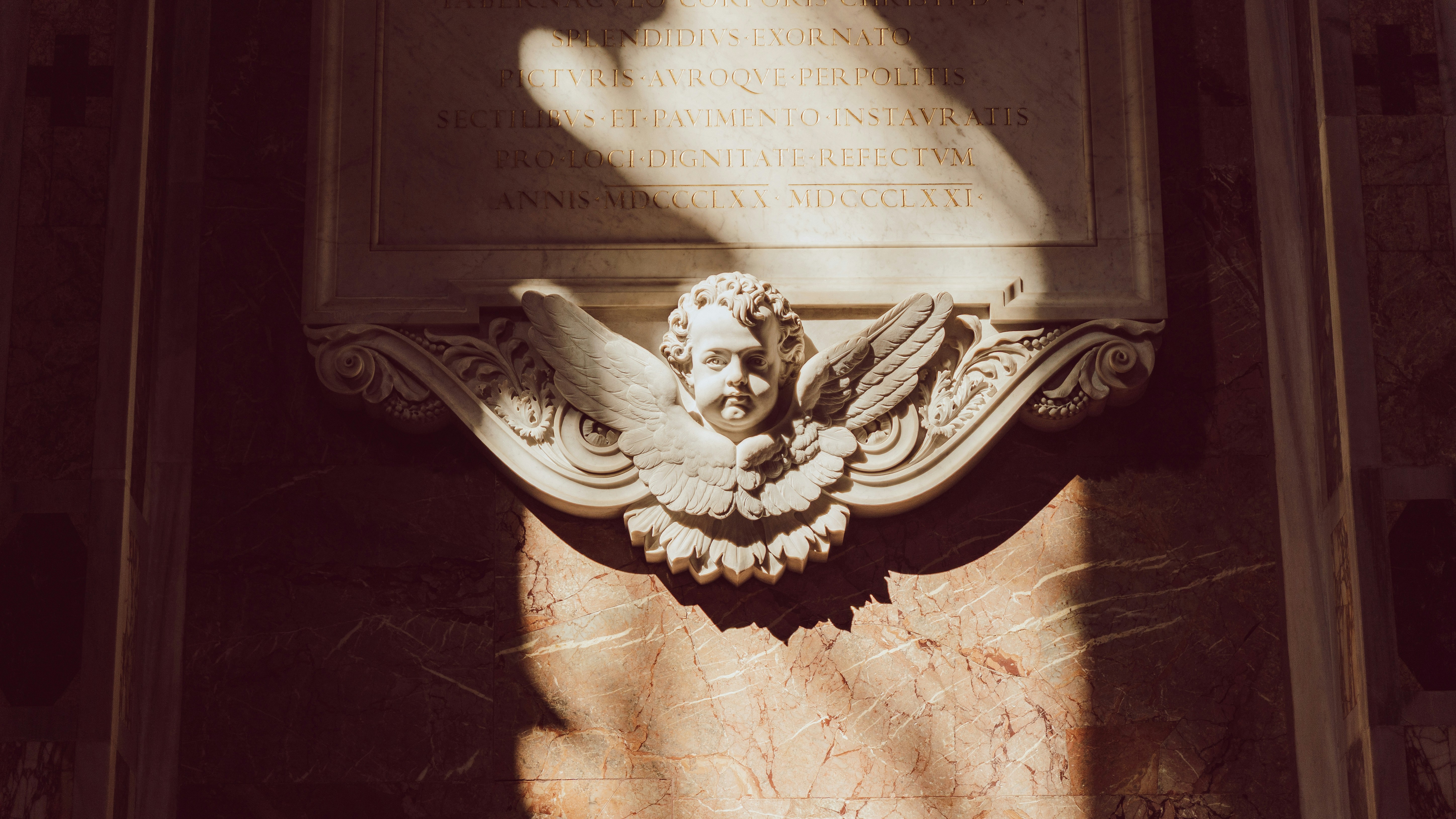 Stone cherub with sunlight casting shadows