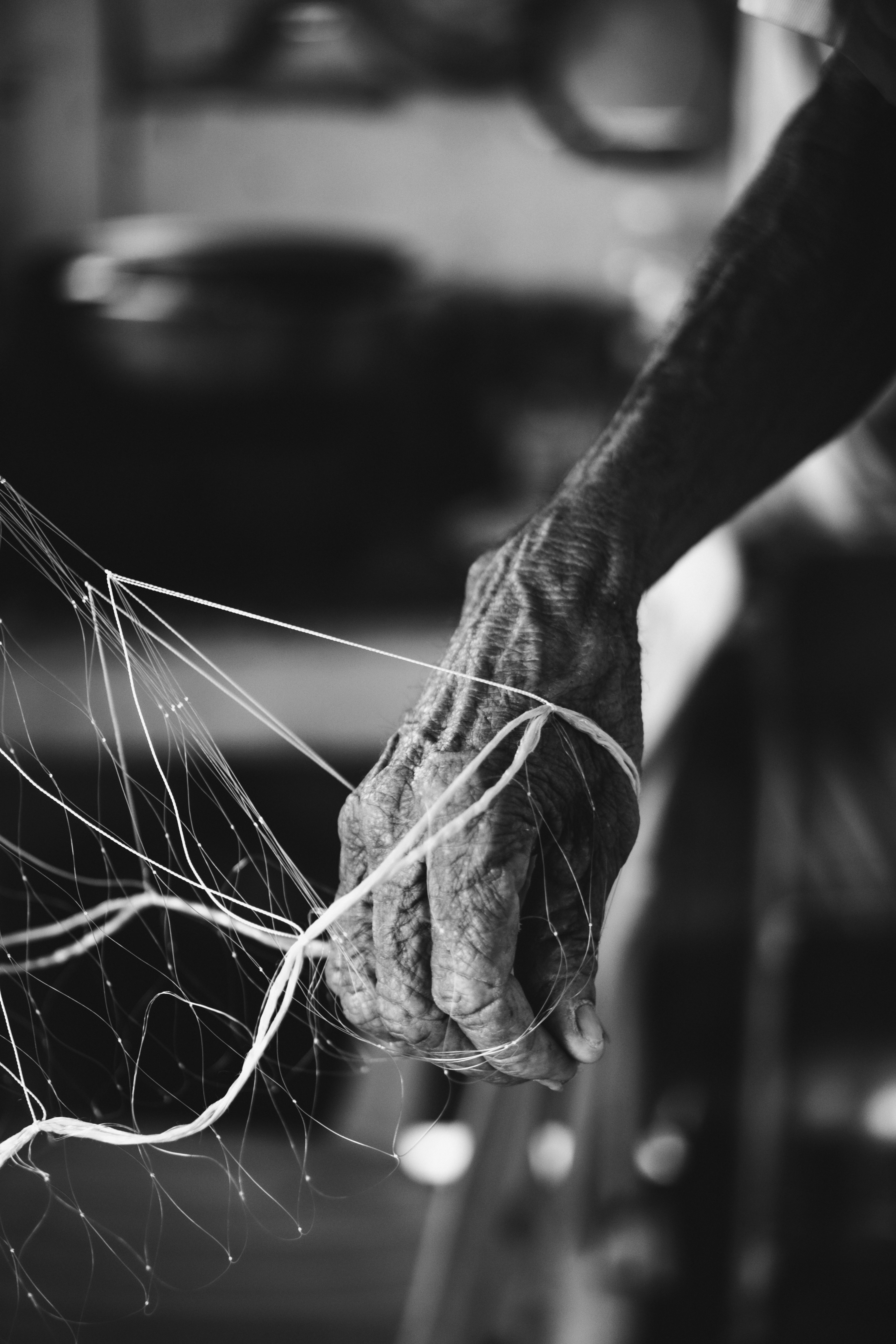 Elderly hands untangling a fishing net