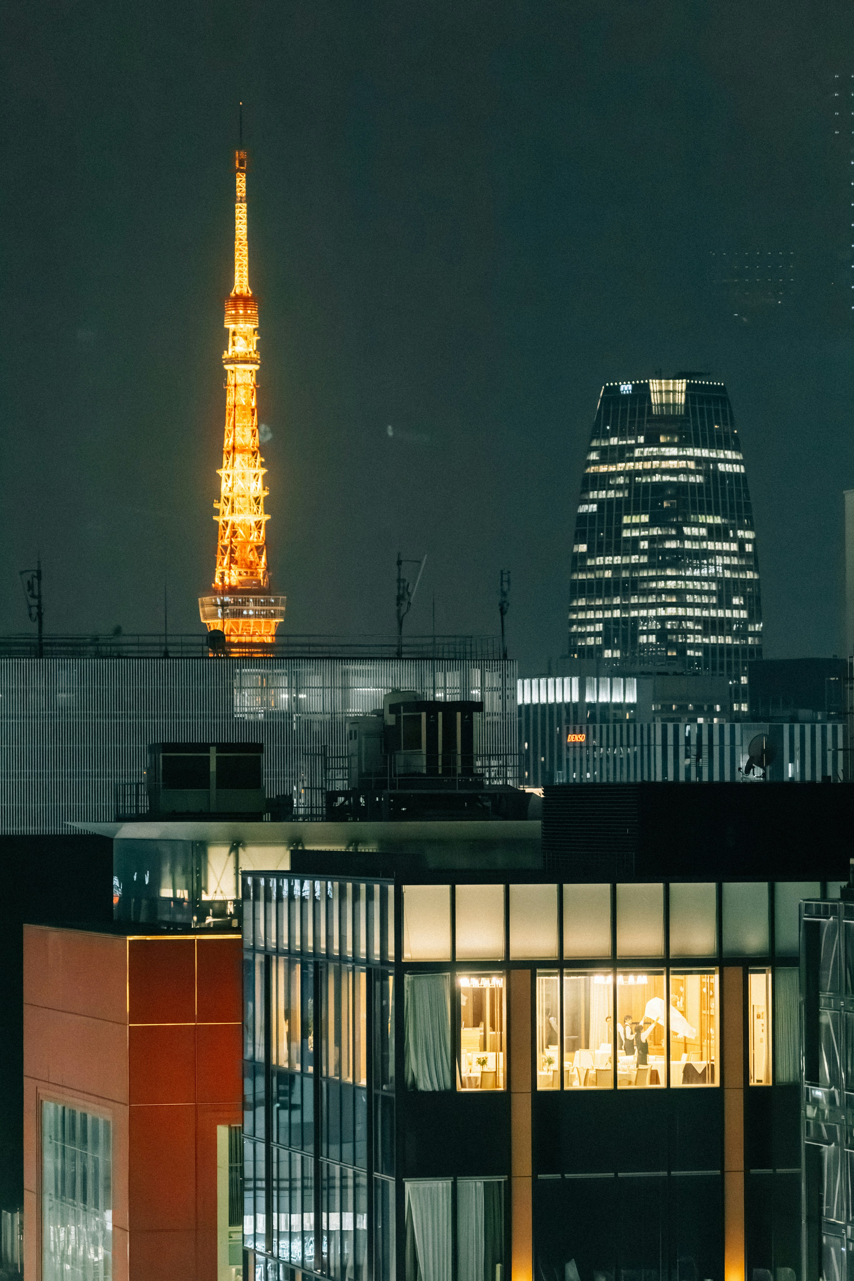 Tokyo tower and illuminated skyscrapers at night