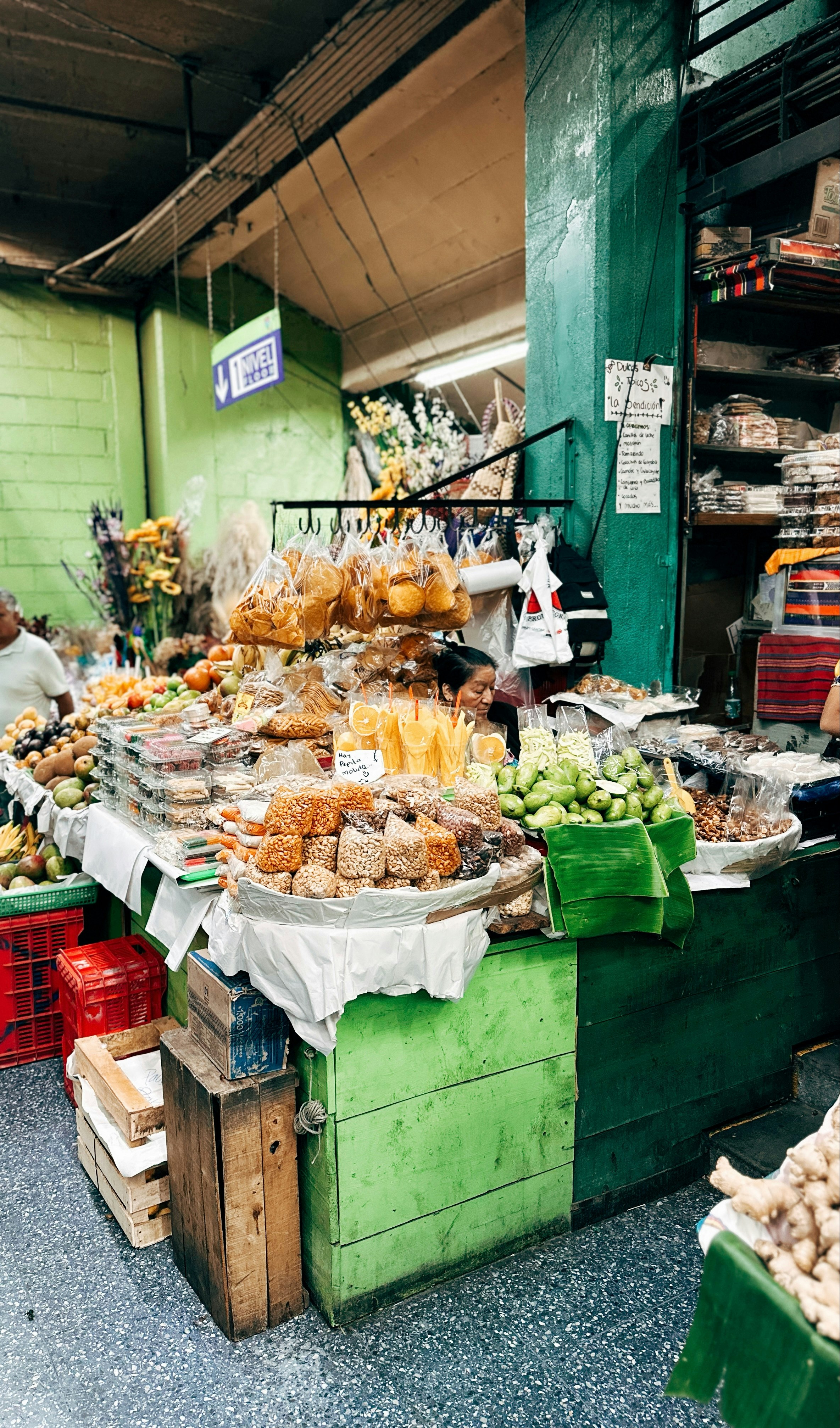 Market stall with fruits, vegetables, and packaged goods