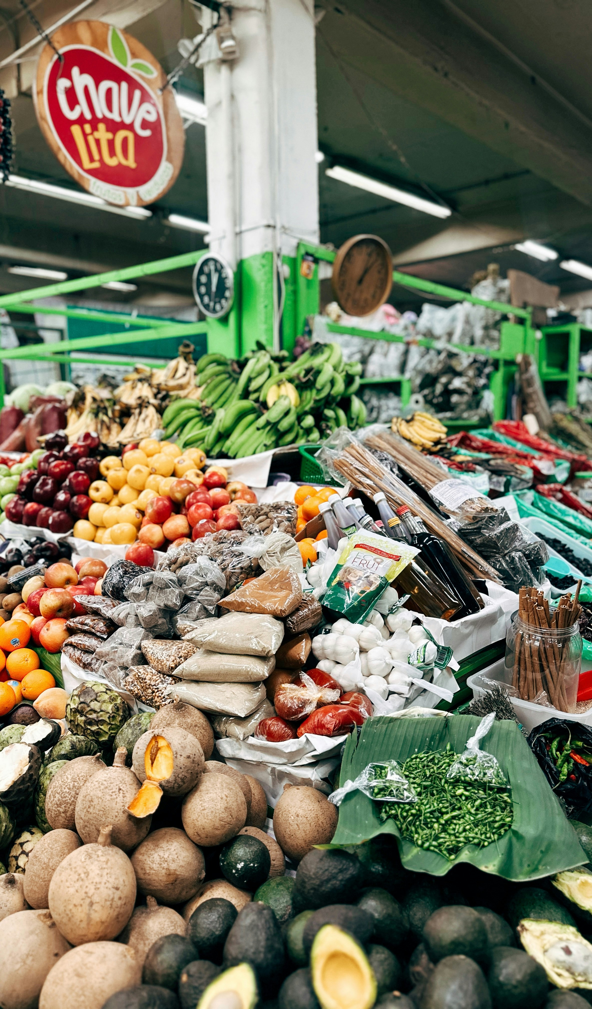Abundant fresh fruits and vegetables displayed at market.