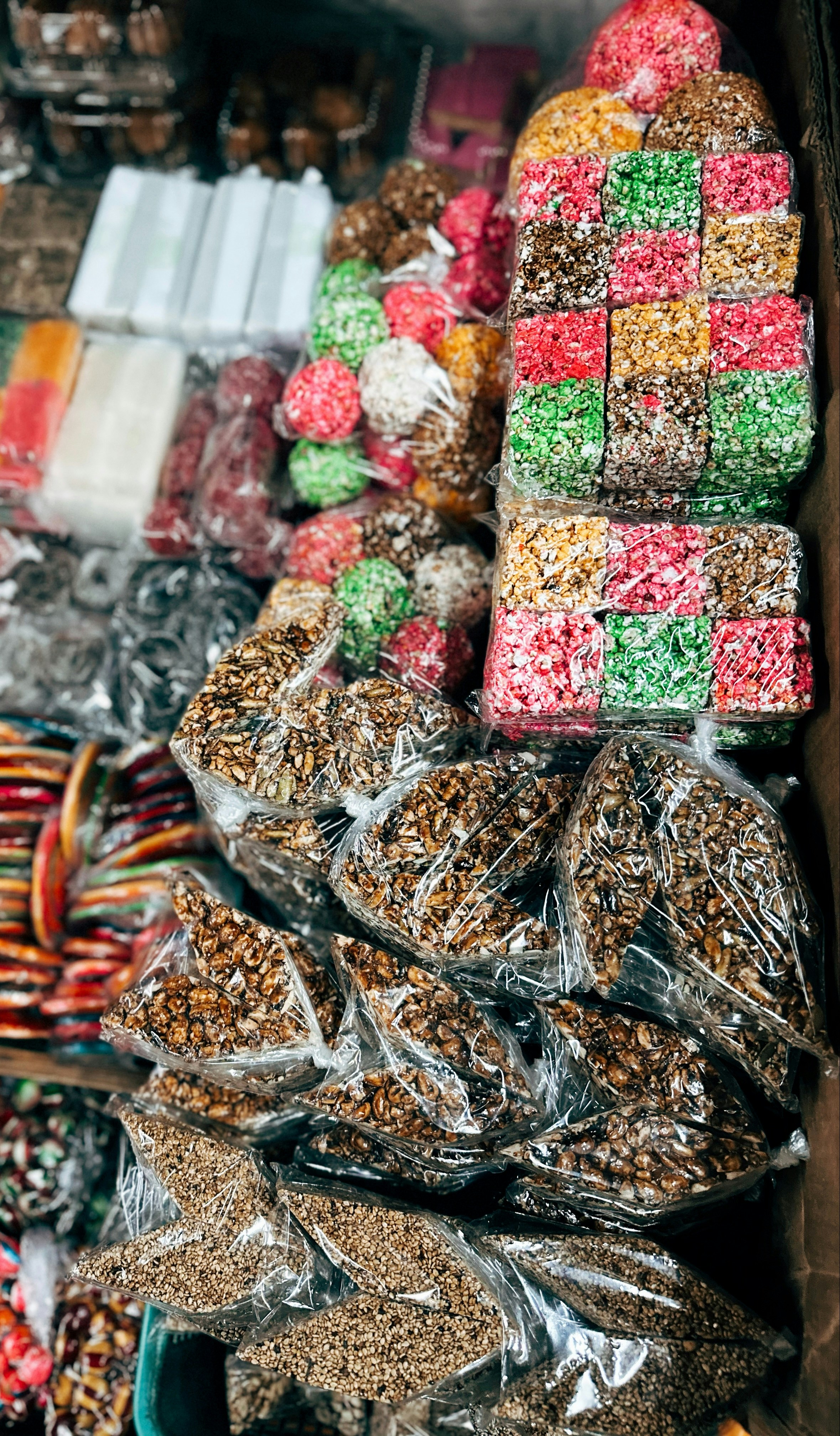 Colorful candies and snacks displayed in plastic packaging.