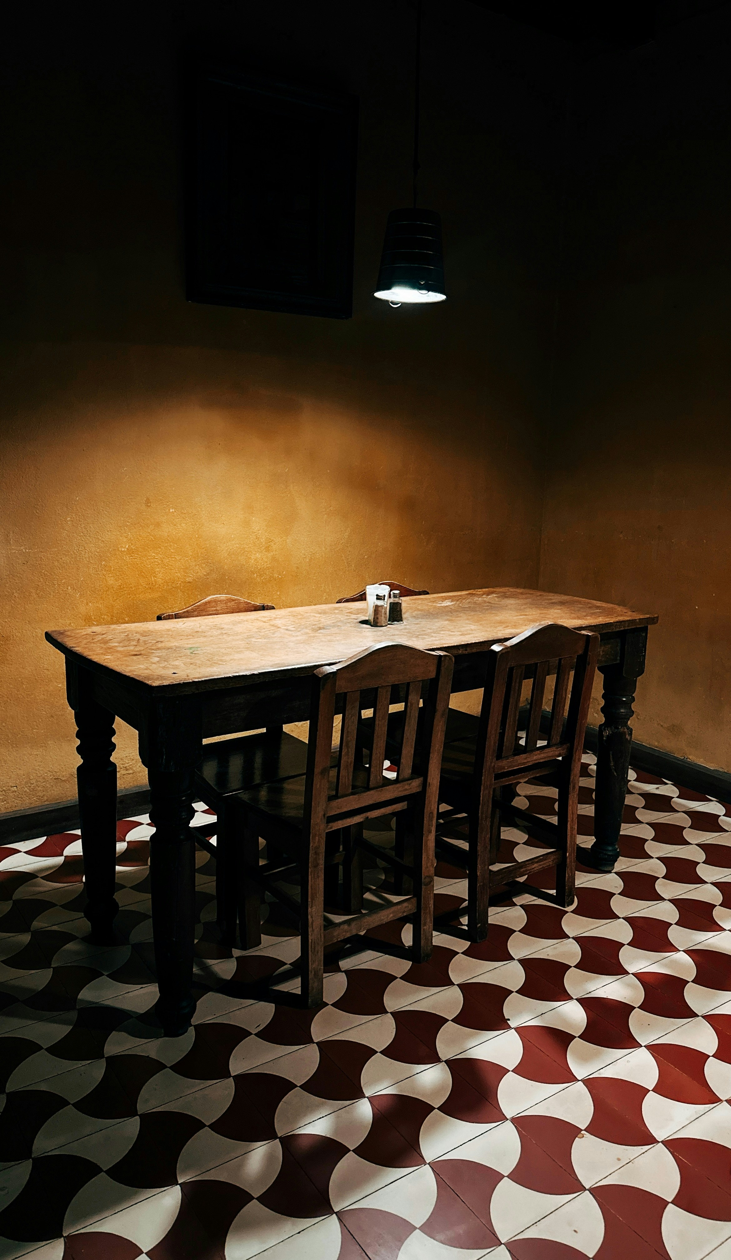 Wooden table and chairs with patterned floor