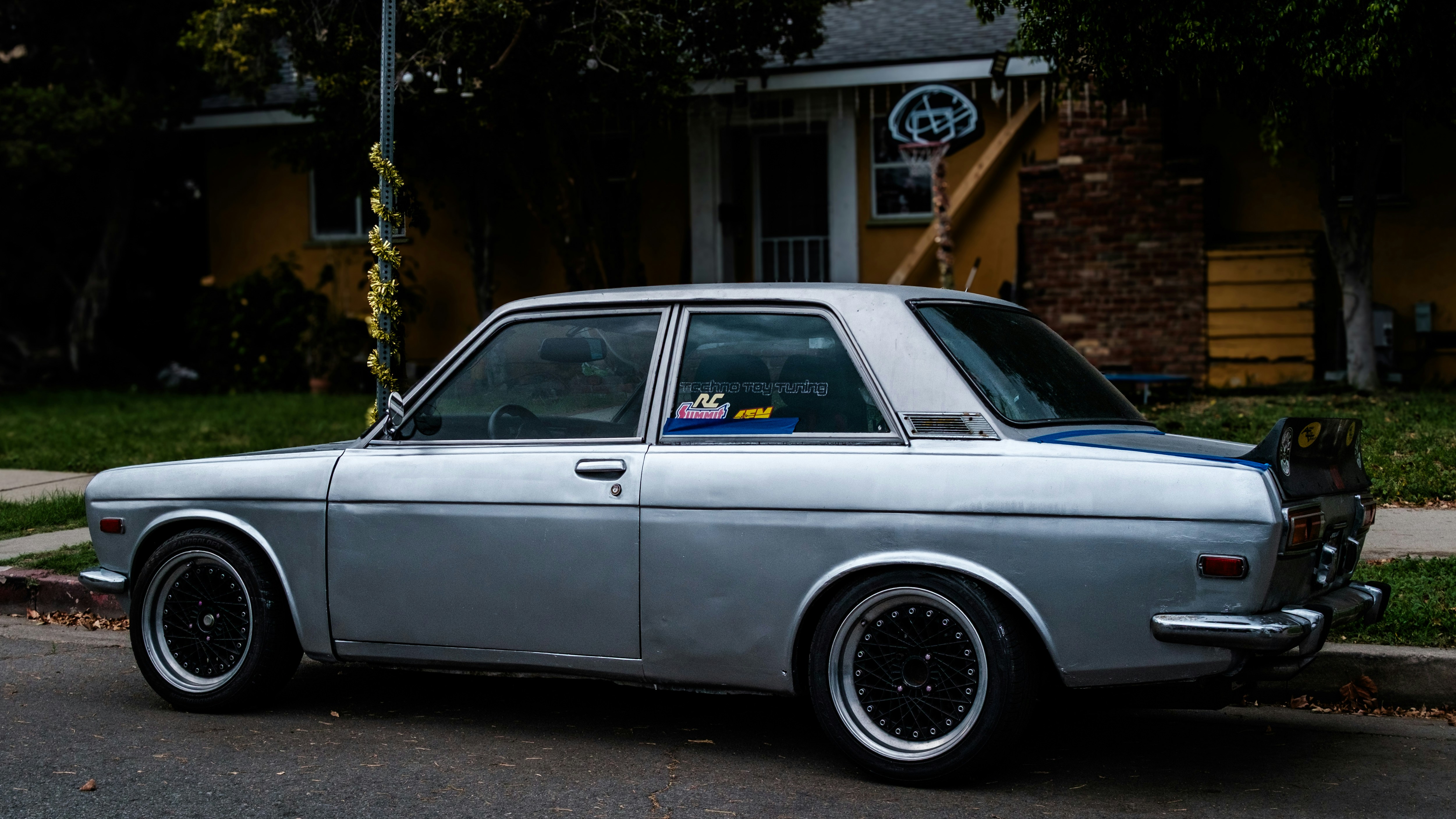 Silver vintage car parked on a street