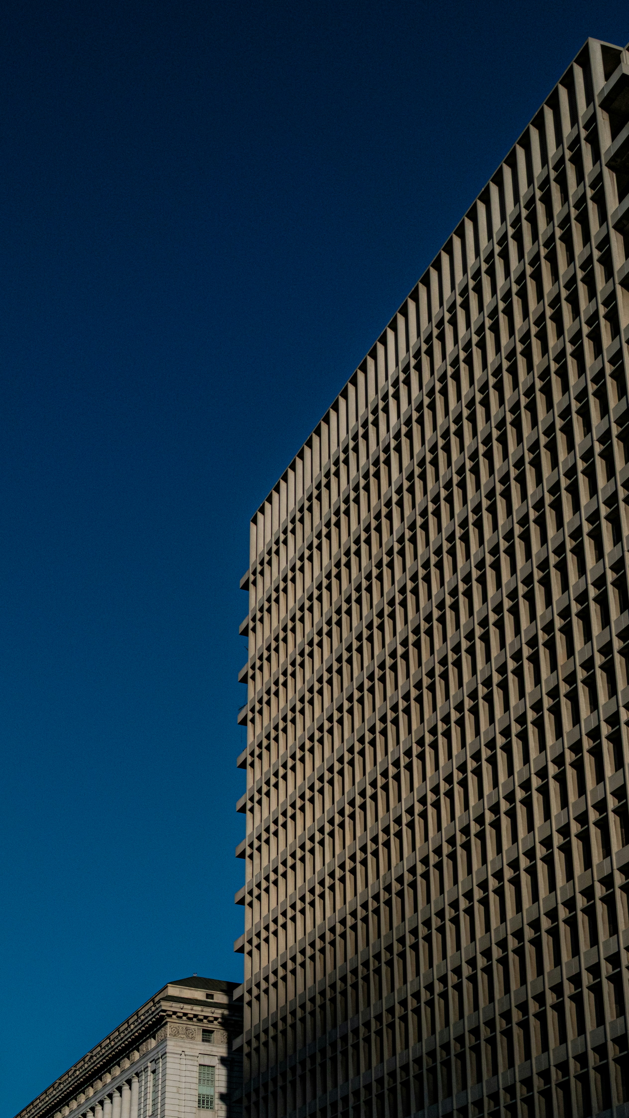 Modern building facade against a clear blue sky
