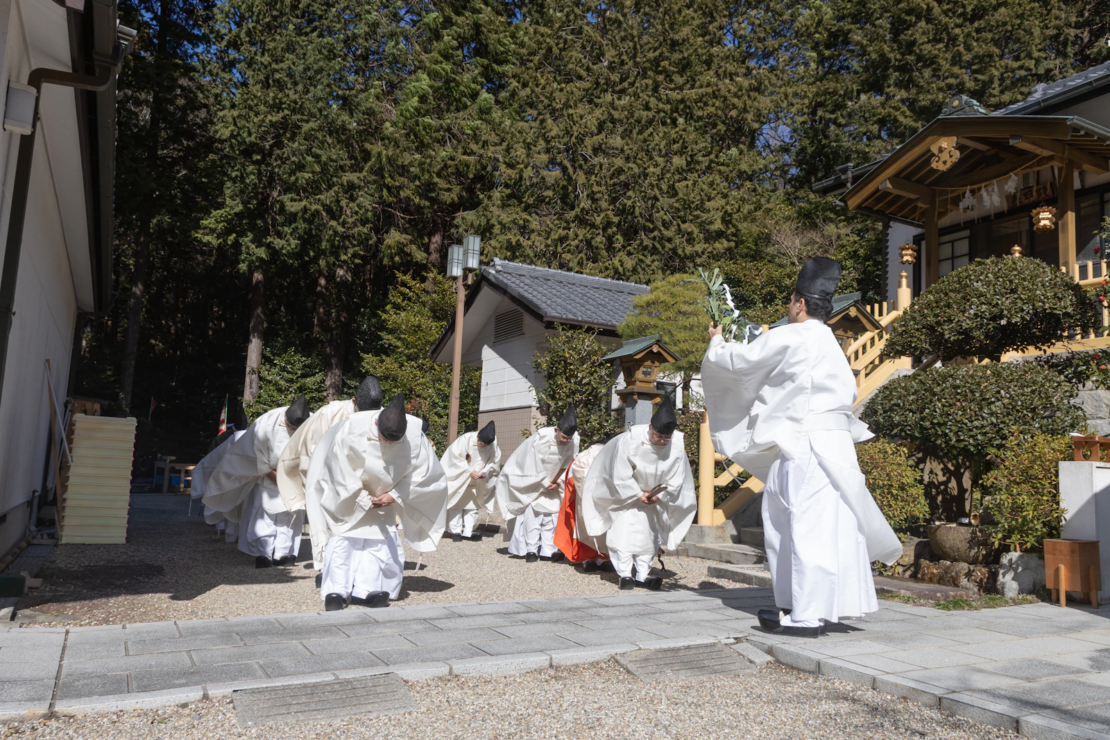 People bowing at a traditional shrine in Japan