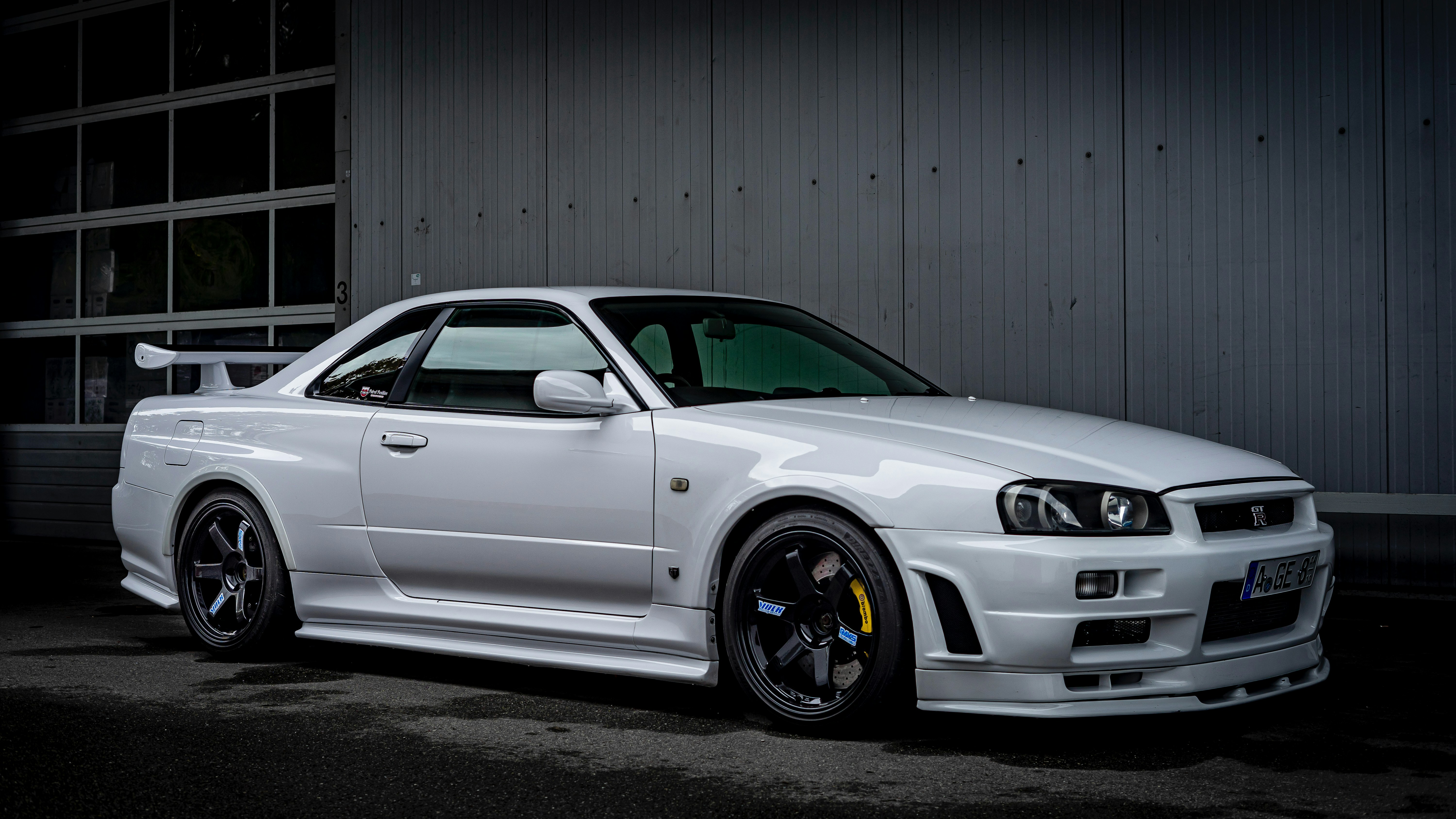 A white sports car parked outside a building.