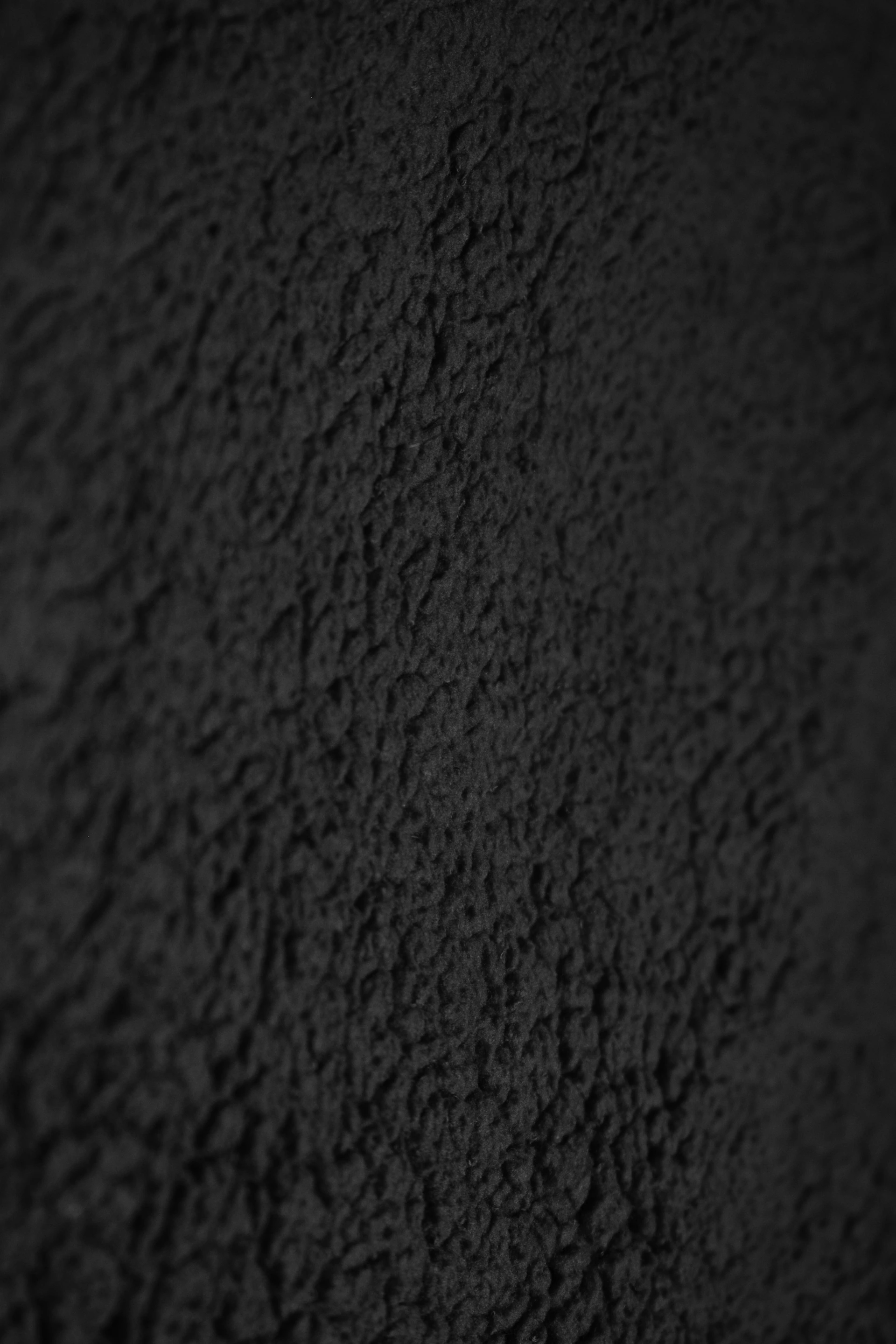 A textured black background with subtle lighting.