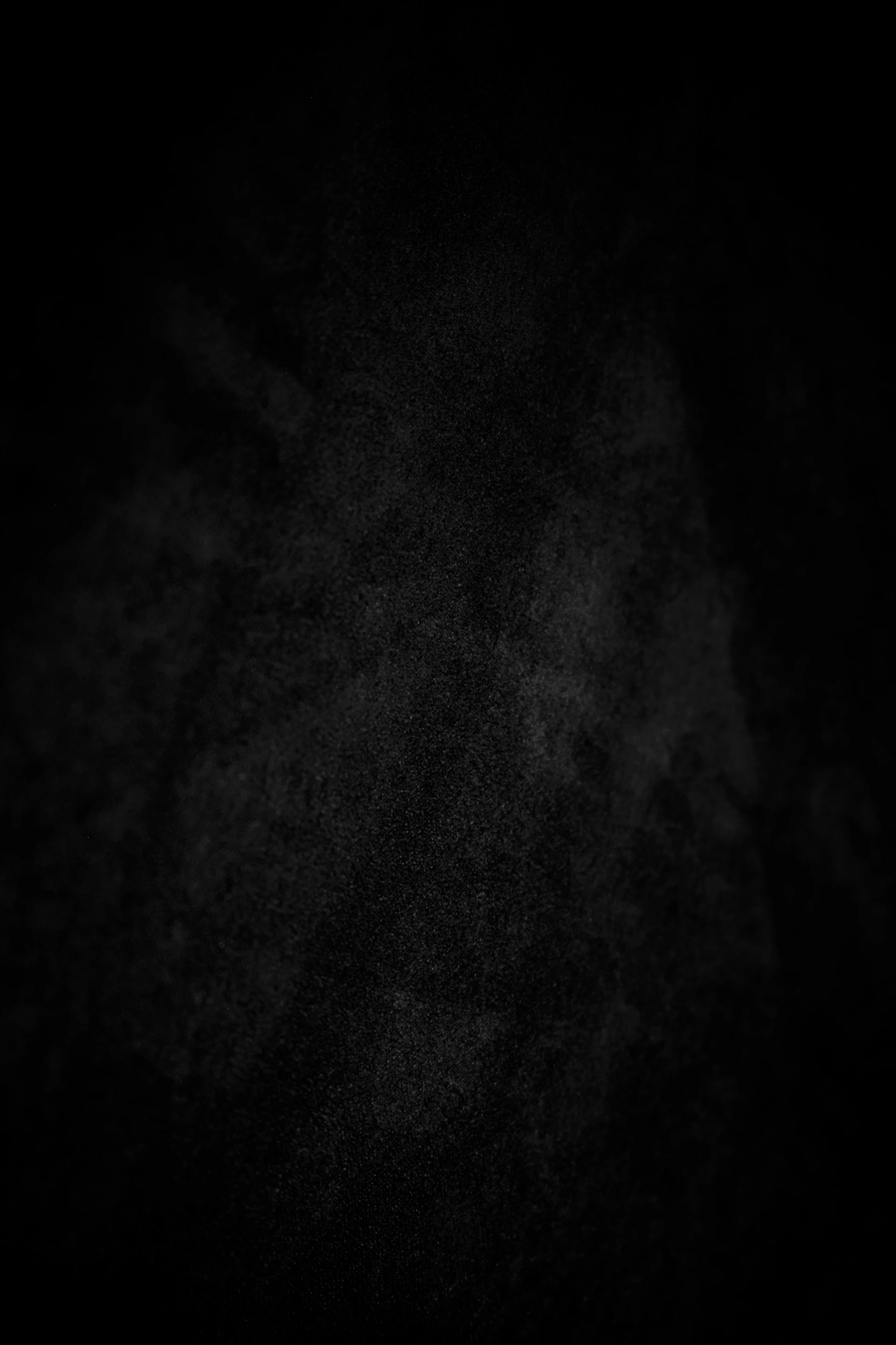 A dark, textured background with subtle white speckles.