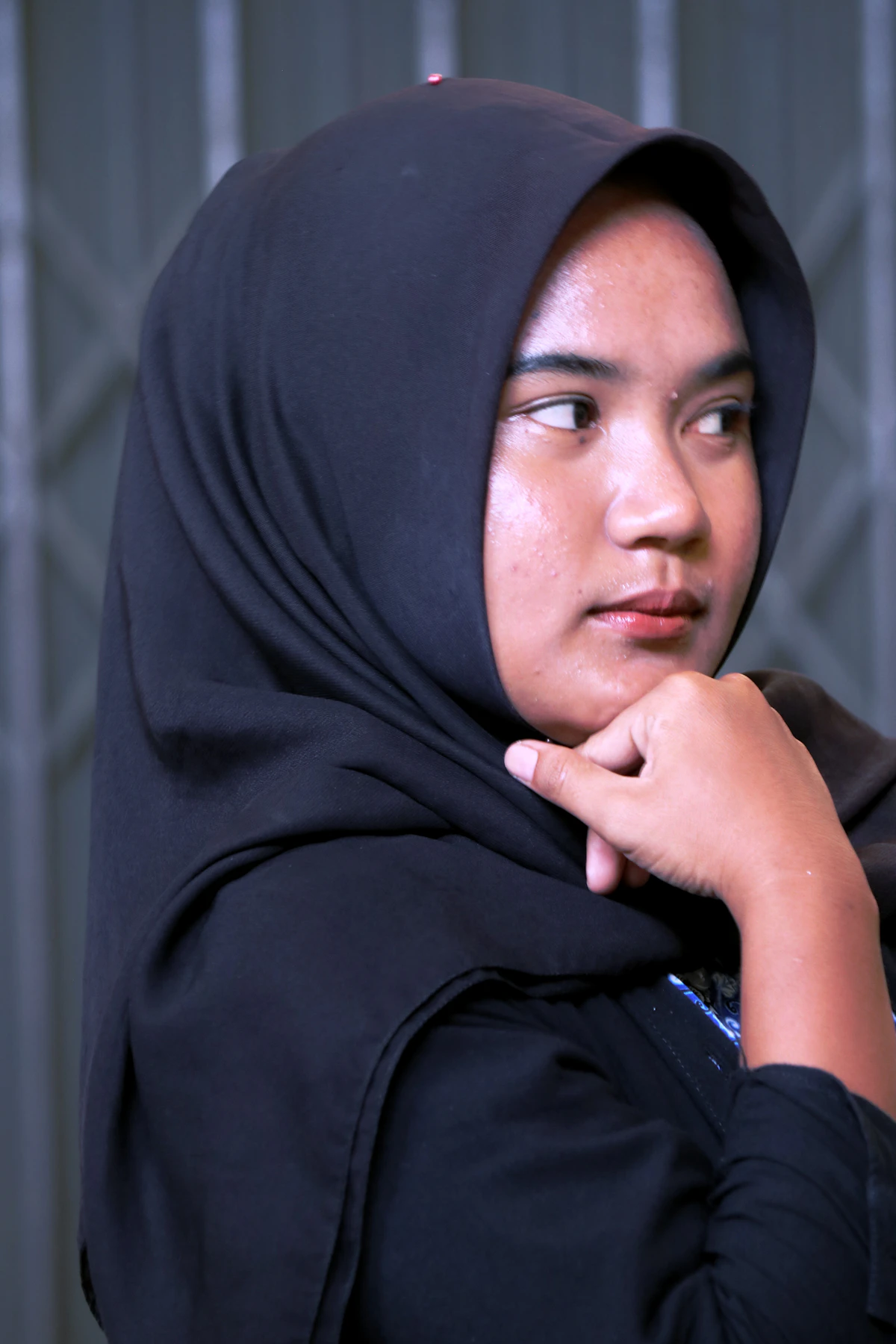 Young woman in hijab looking away in quiet thought — Islamophobia and mental health support Canada