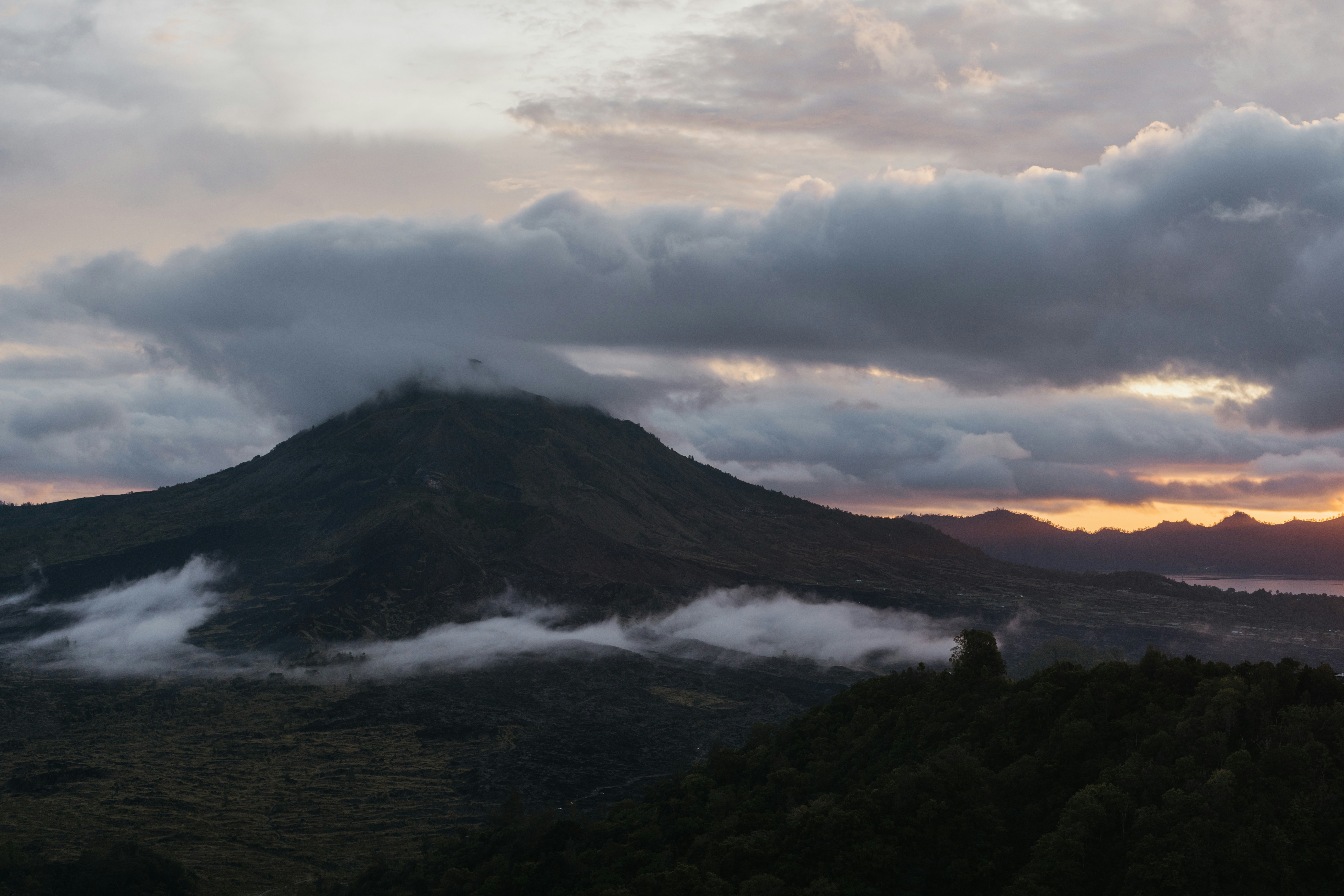 Misty mountain landscape at sunrise with dramatic clouds