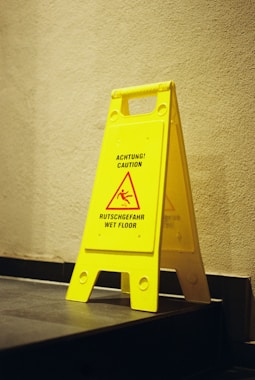 Yellow caution sign for wet floor