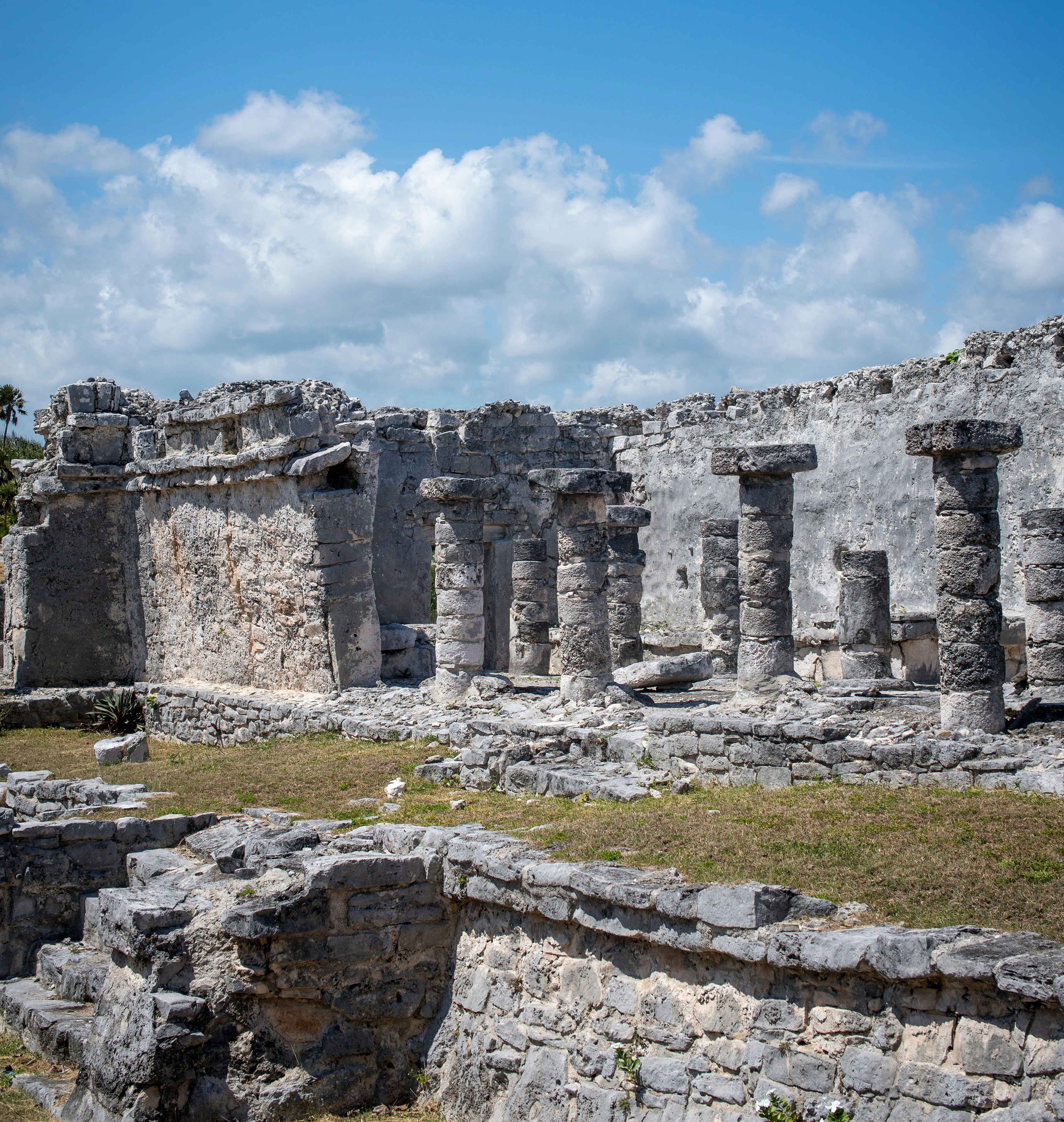 Ancient stone ruins with columns under a blue sky