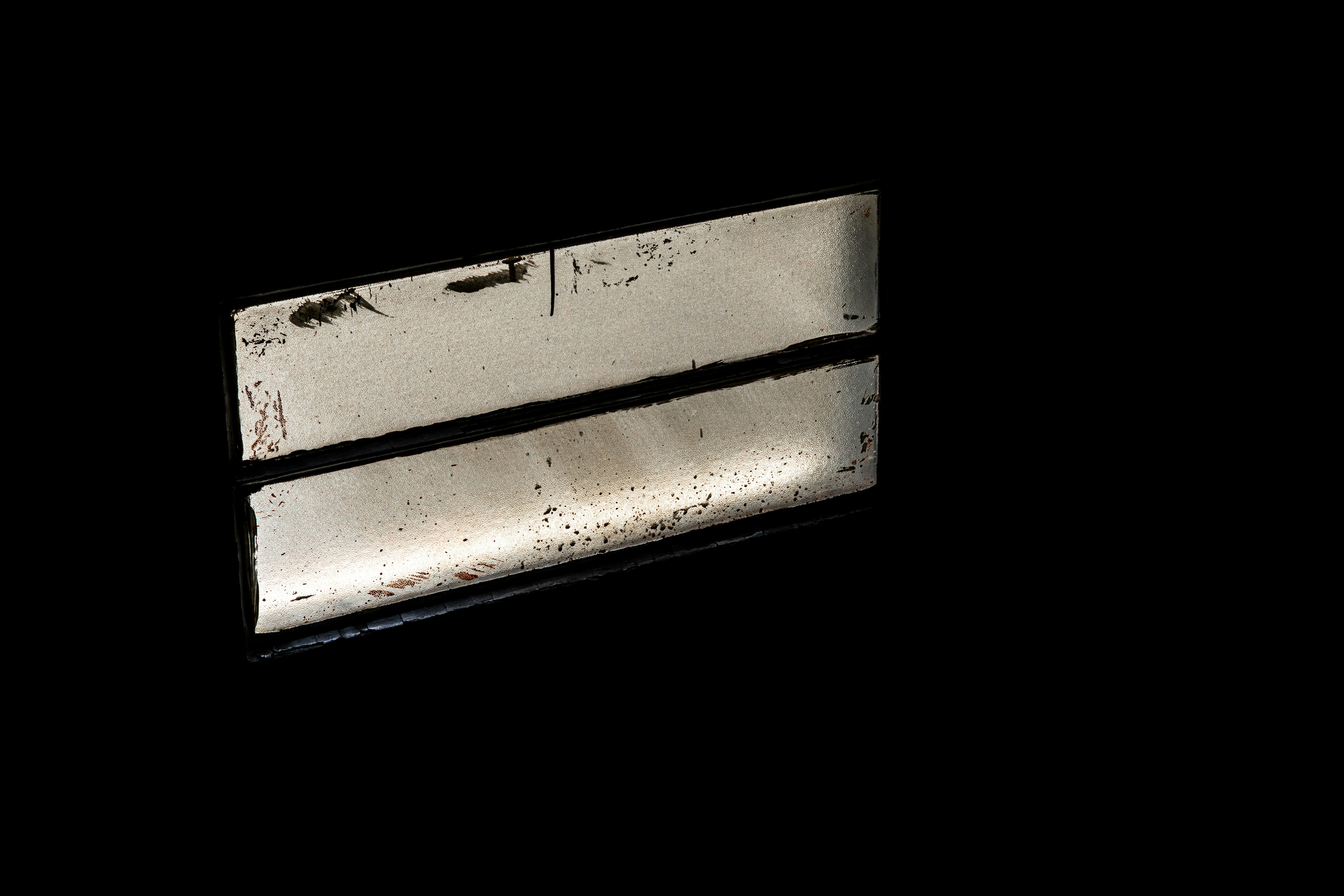 A metal object against a black background