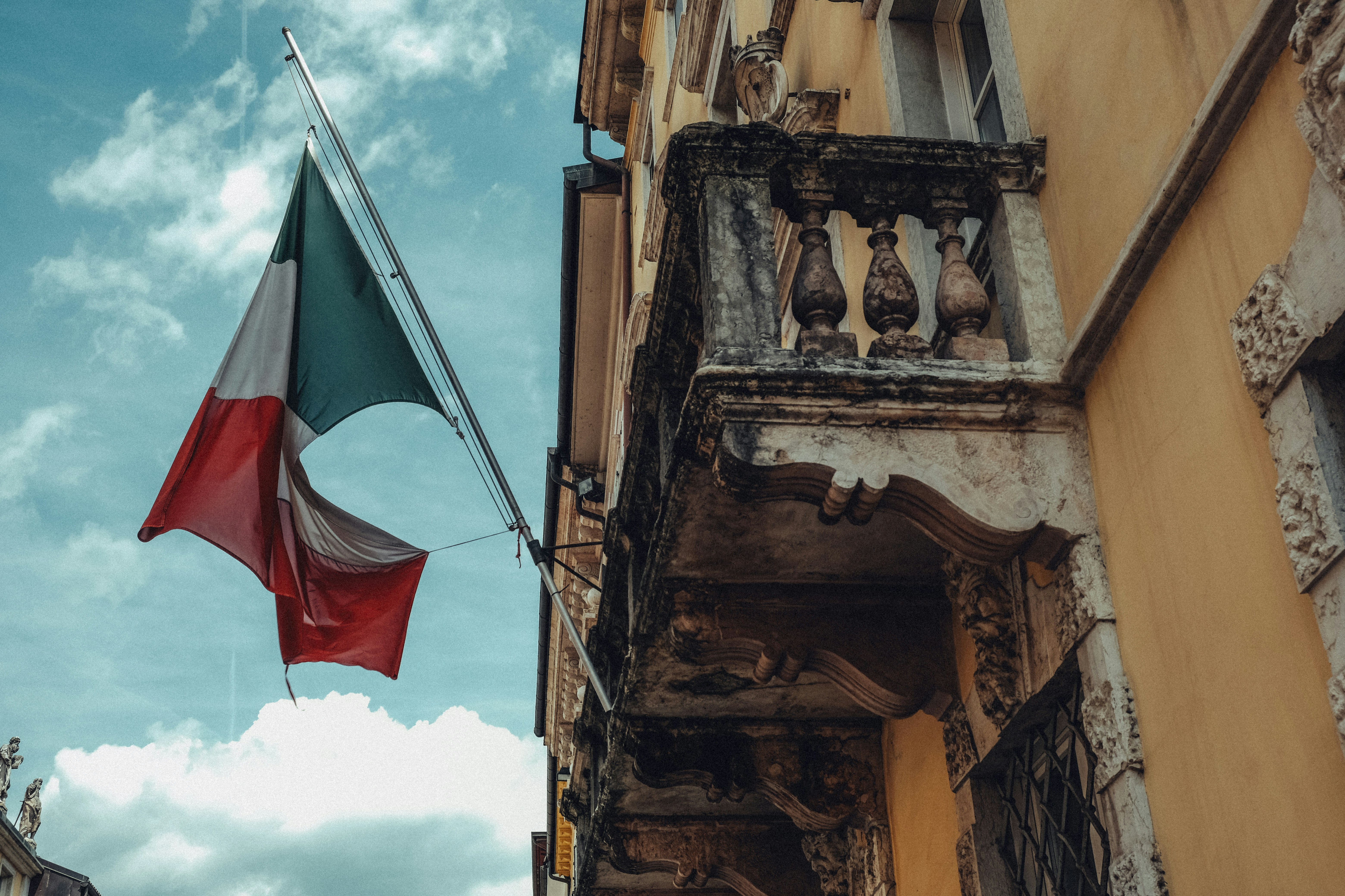 Italian flag waving on a building balcony