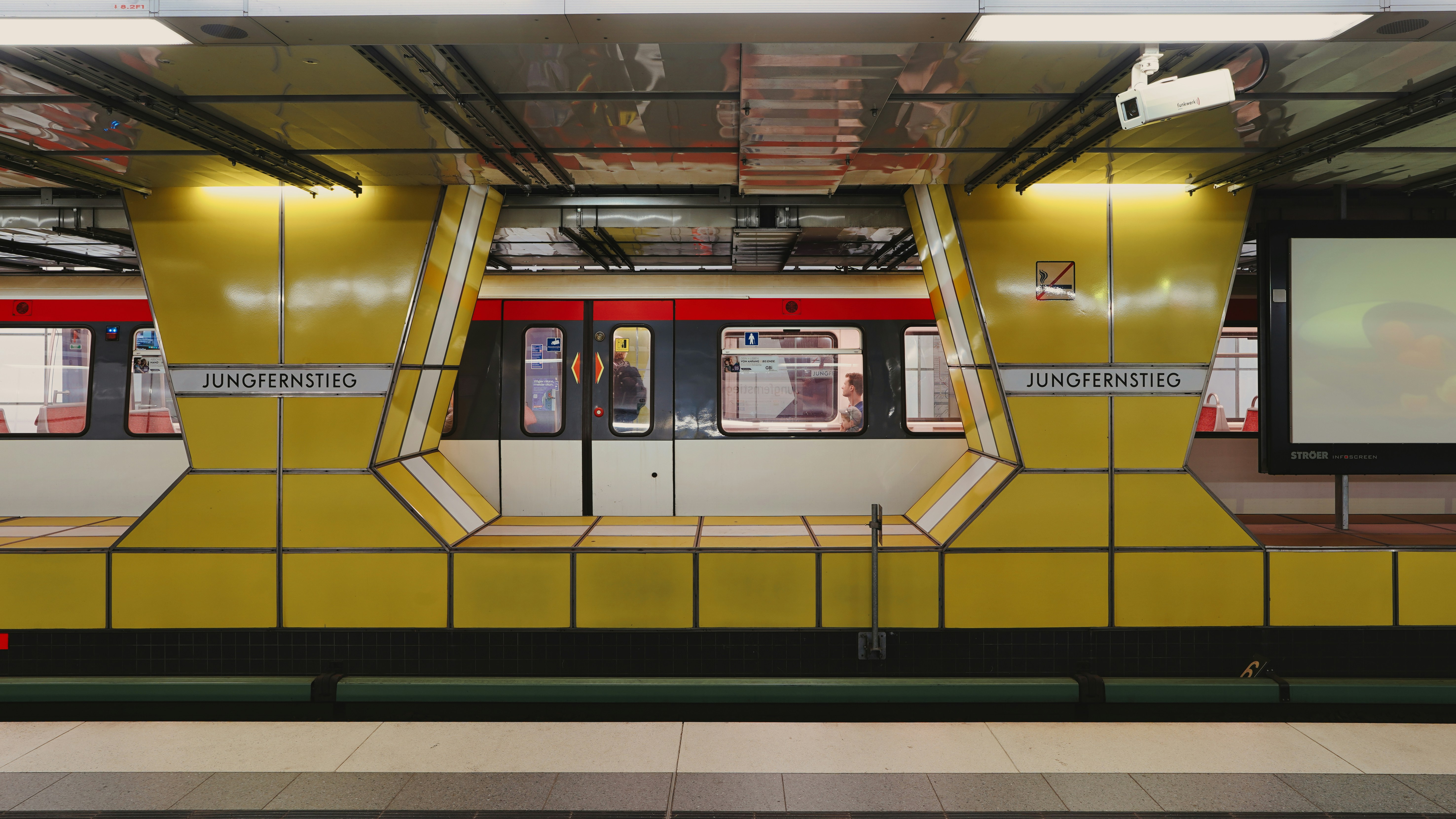 Modern subway station with a train arriving