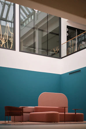 Modern pink seating area in a bright atrium