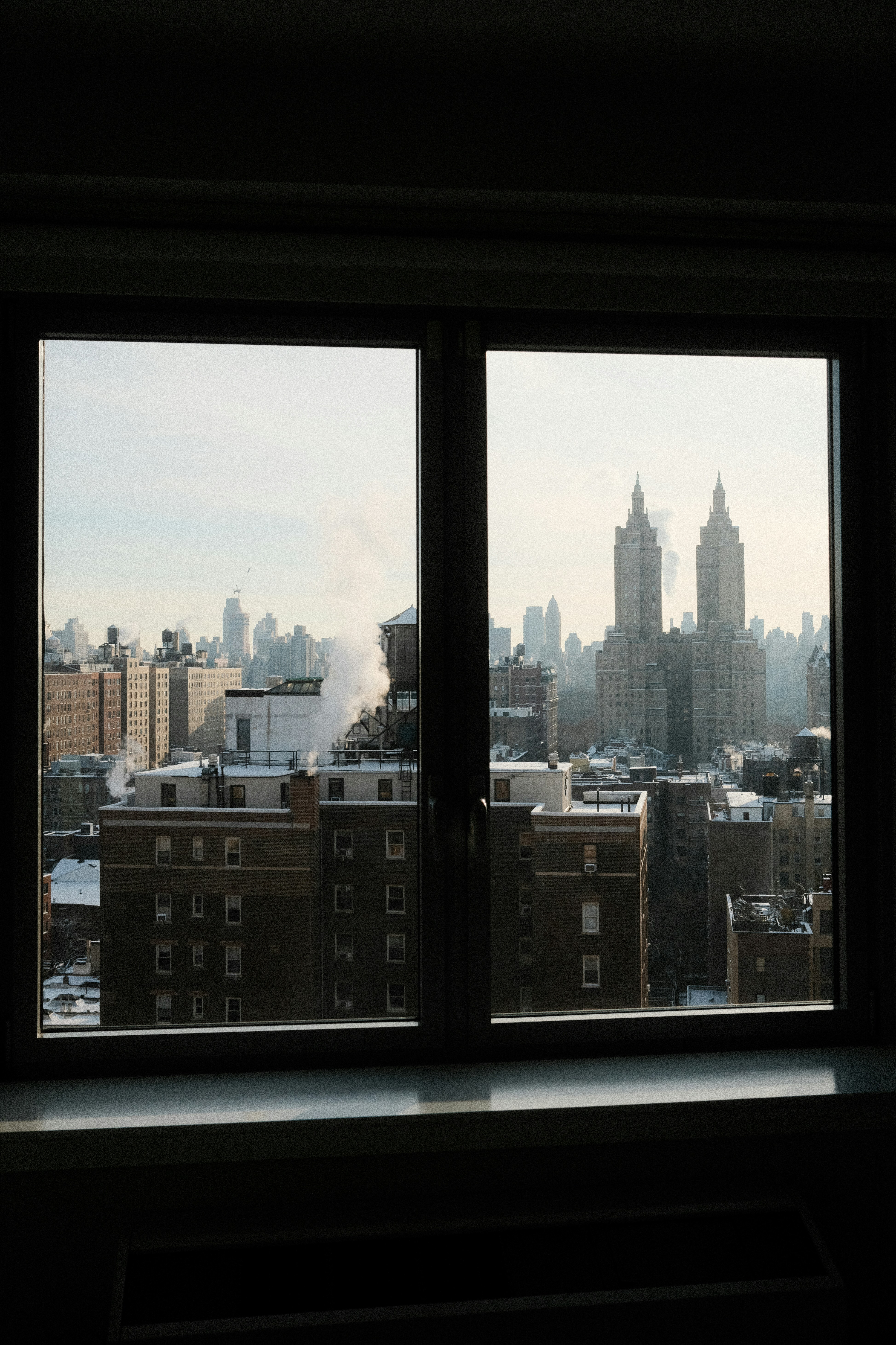 City skyline seen through a window on a hazy day