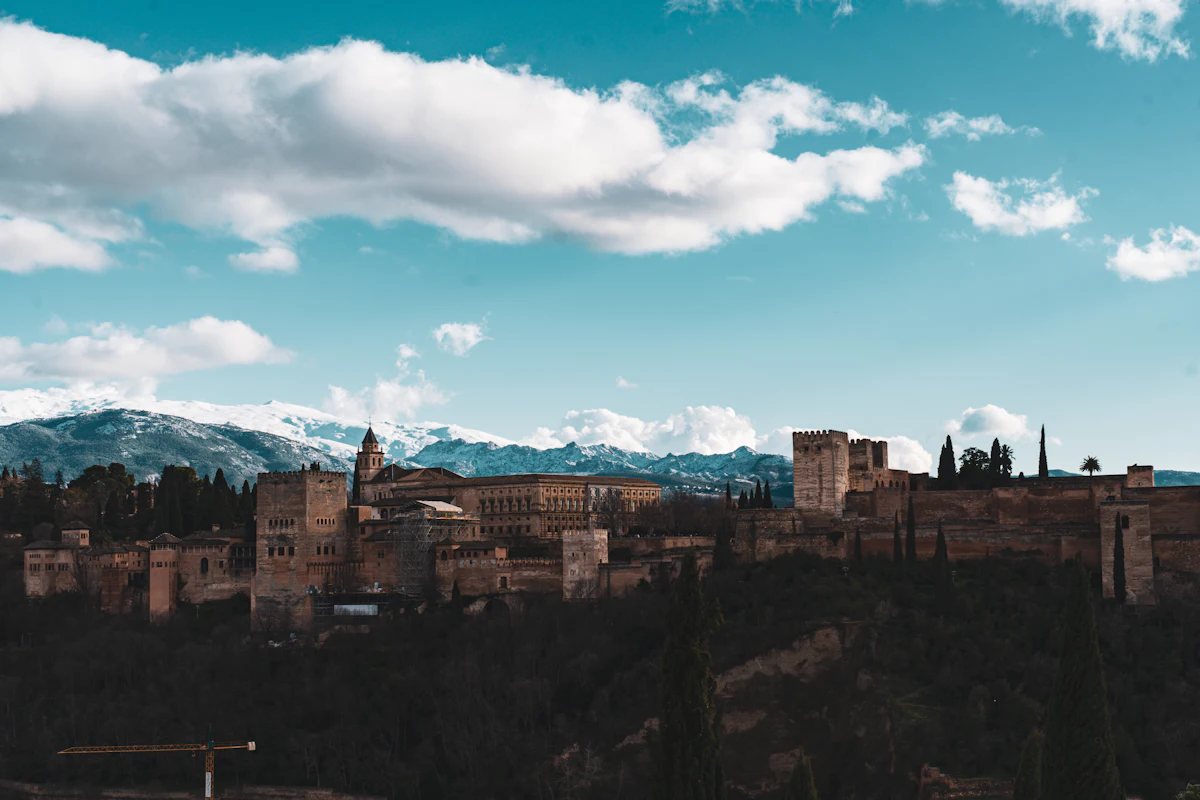 The Alhambra on its hill above Granada, with snowy mountains behind