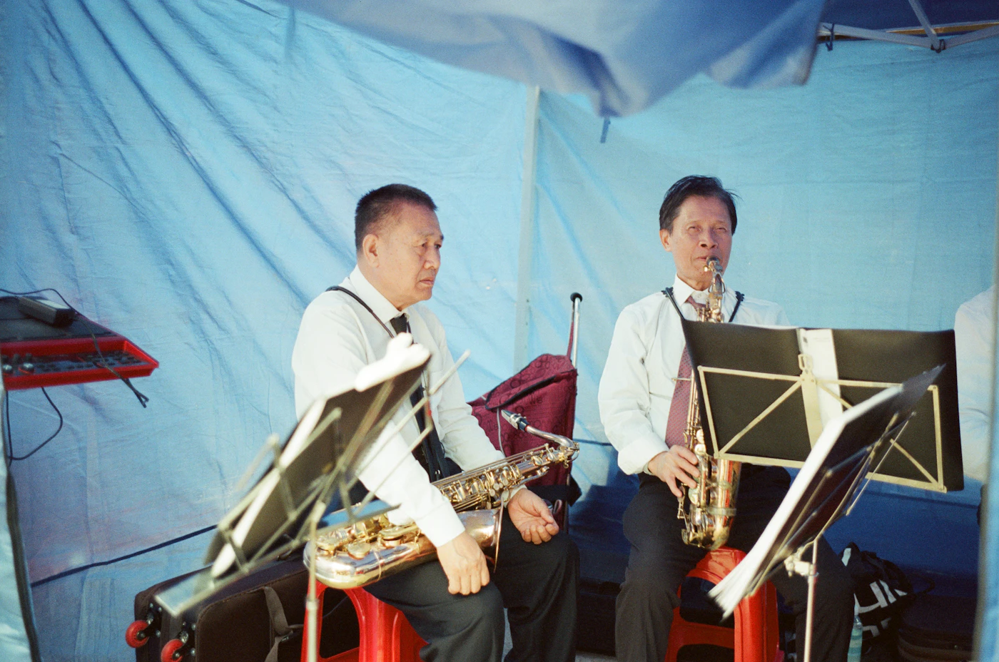Two saxophonists indoors