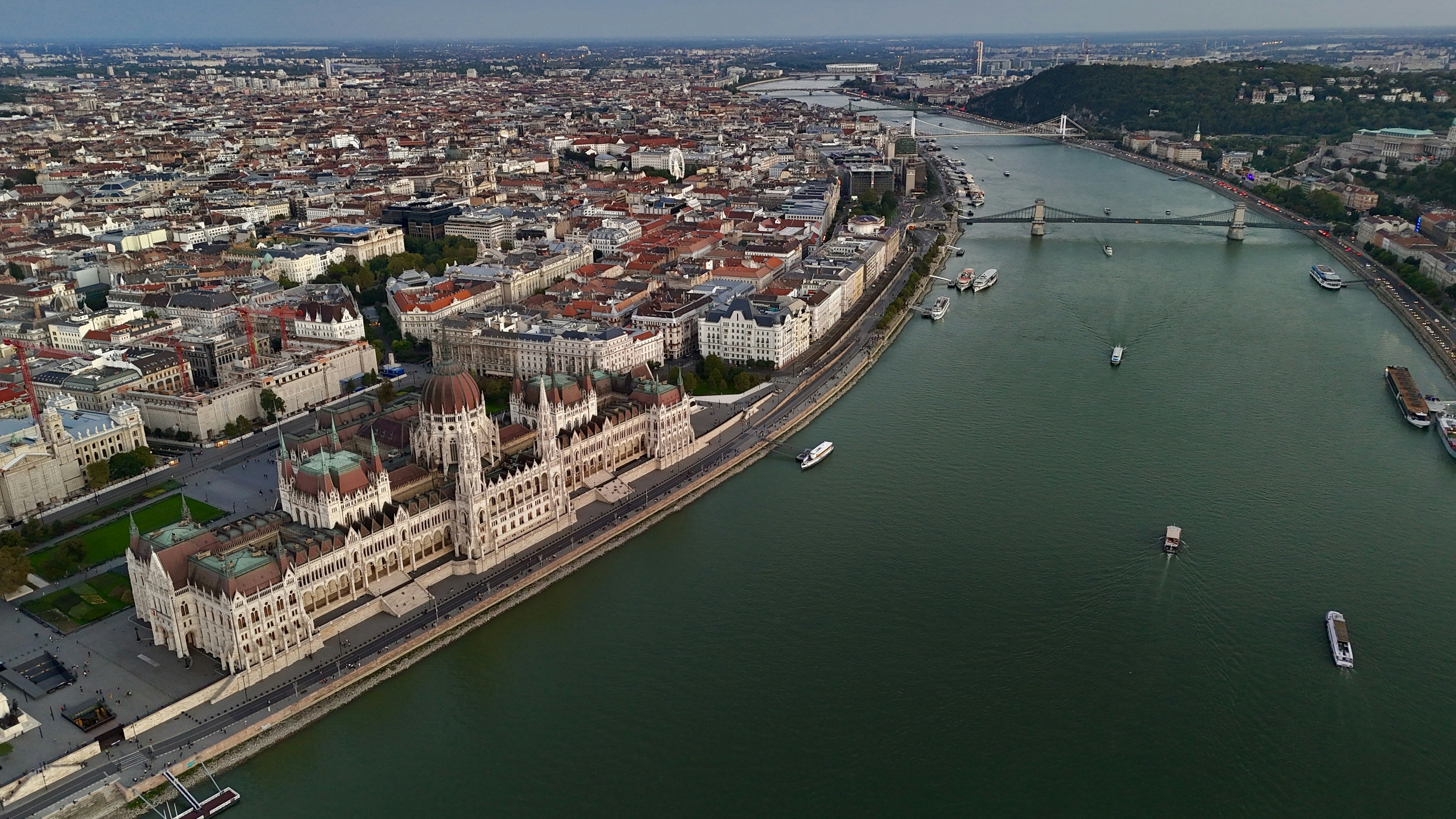 Parliament building on river bank in european city.