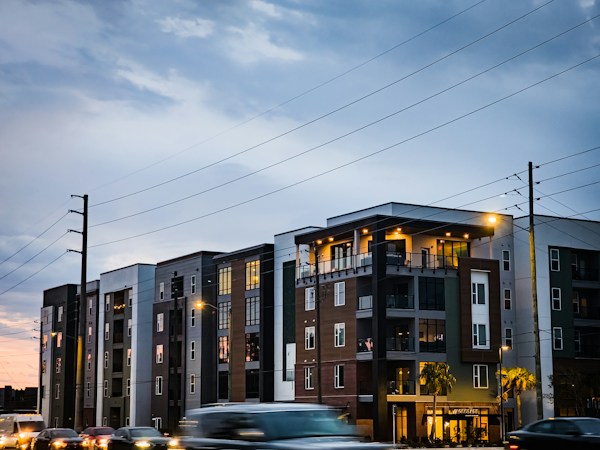 Modern apartment buildings with cars parked along the street, showing the newer rental supply that has kept concessions high in cities like Las Vegas