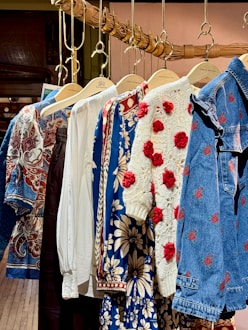 Assorted patterned clothing items hanging on display.