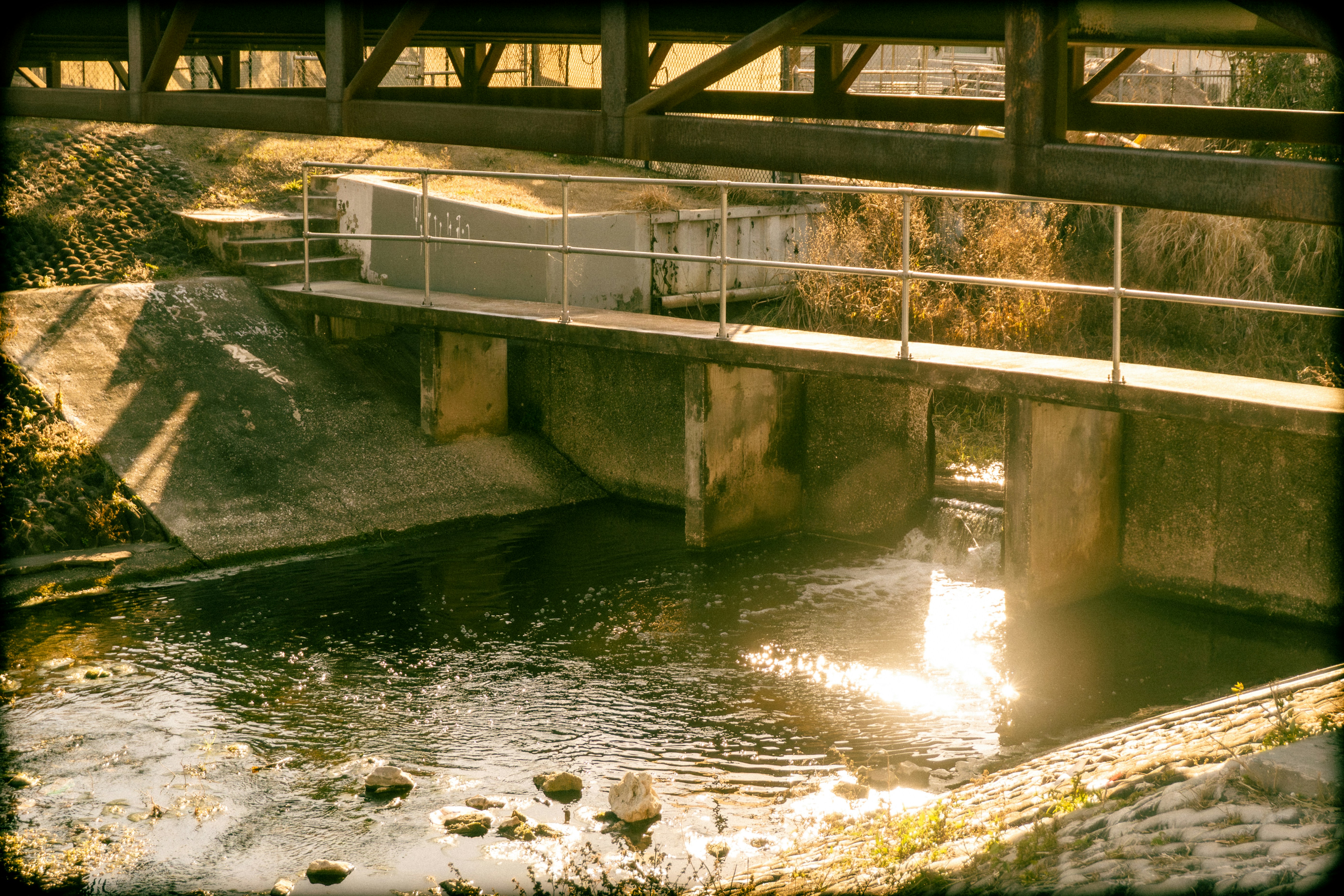 Concrete channel with a bridge and flowing water