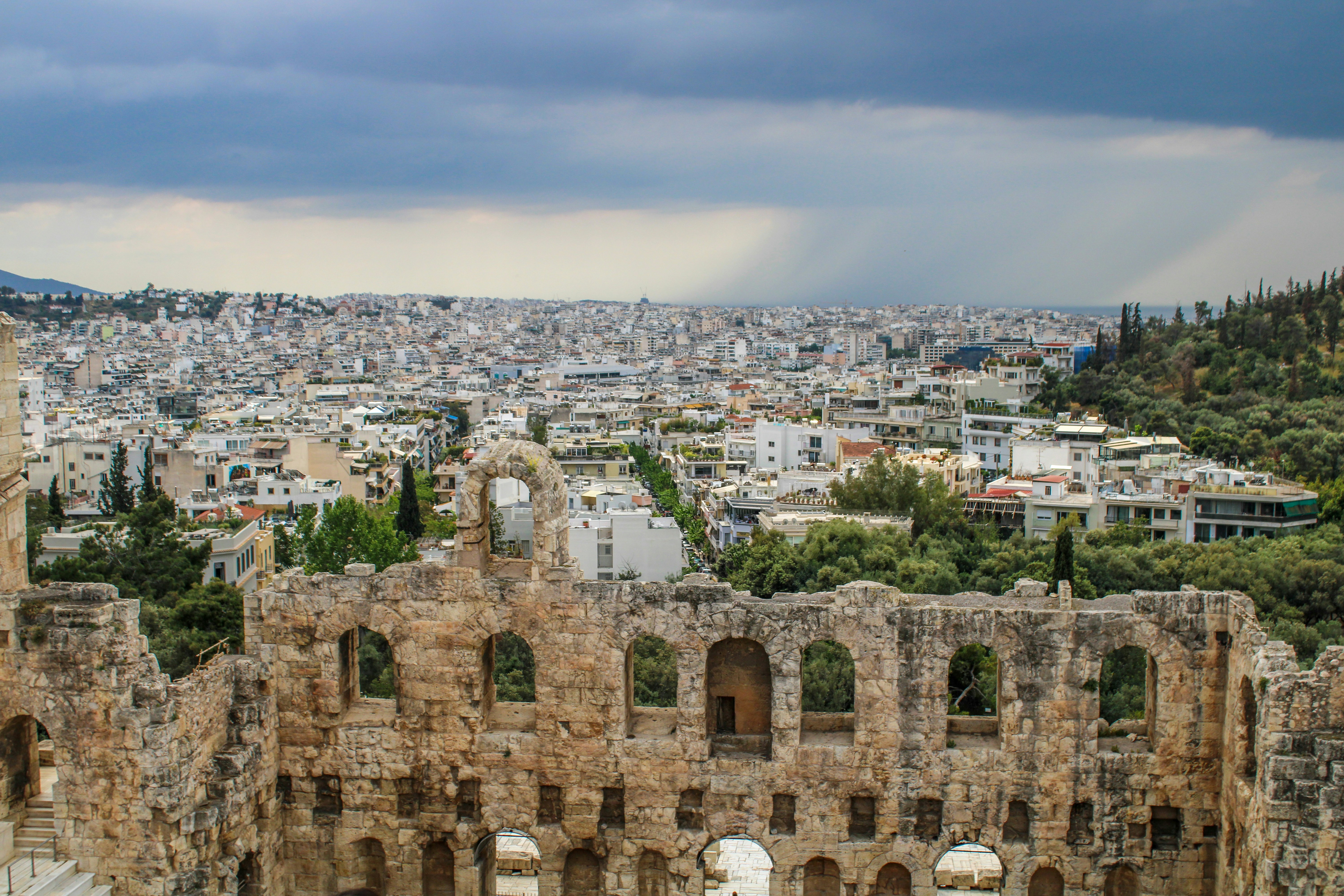 Ancient ruins overlook a sprawling modern city.