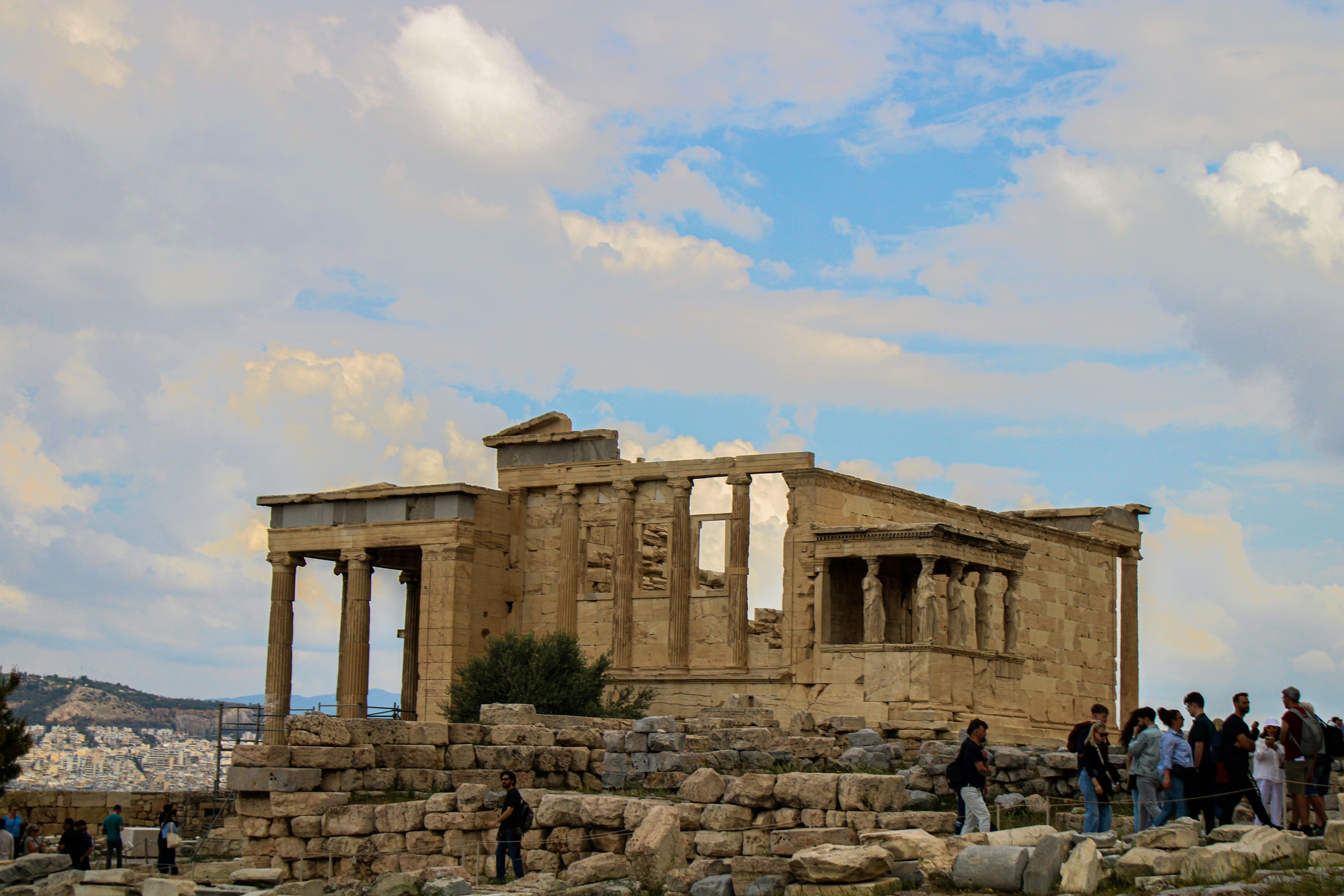 Ancient greek temple ruins with tourists below