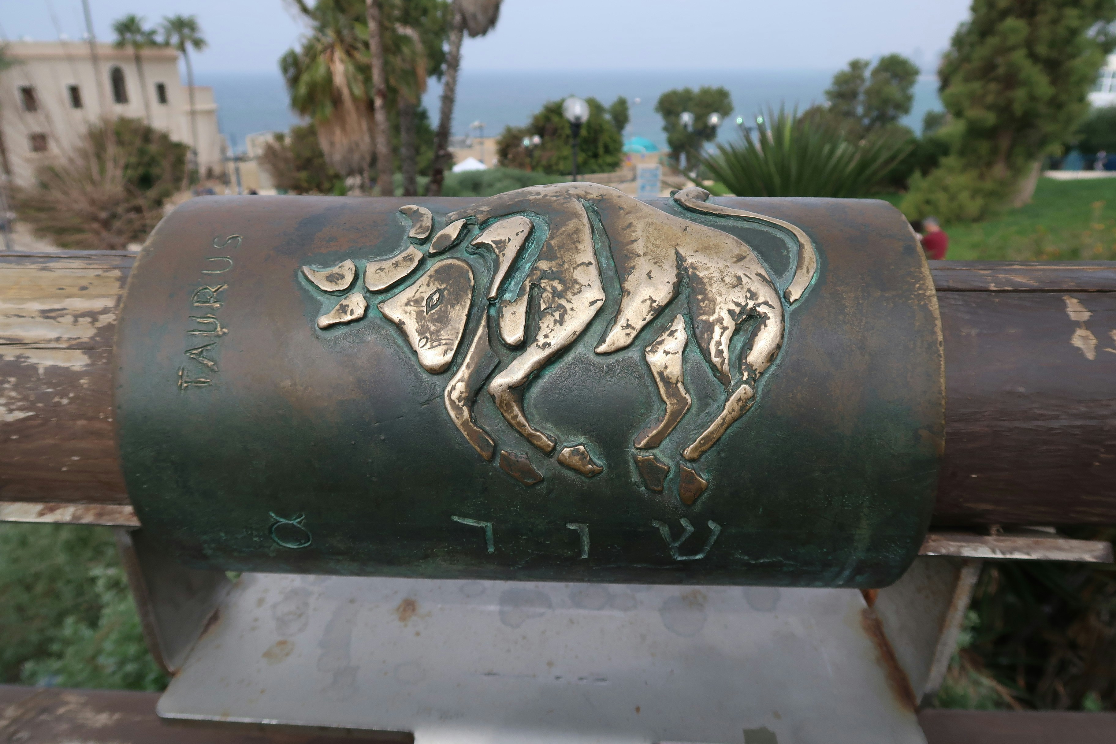 Bronze bull relief on a cylindrical monument