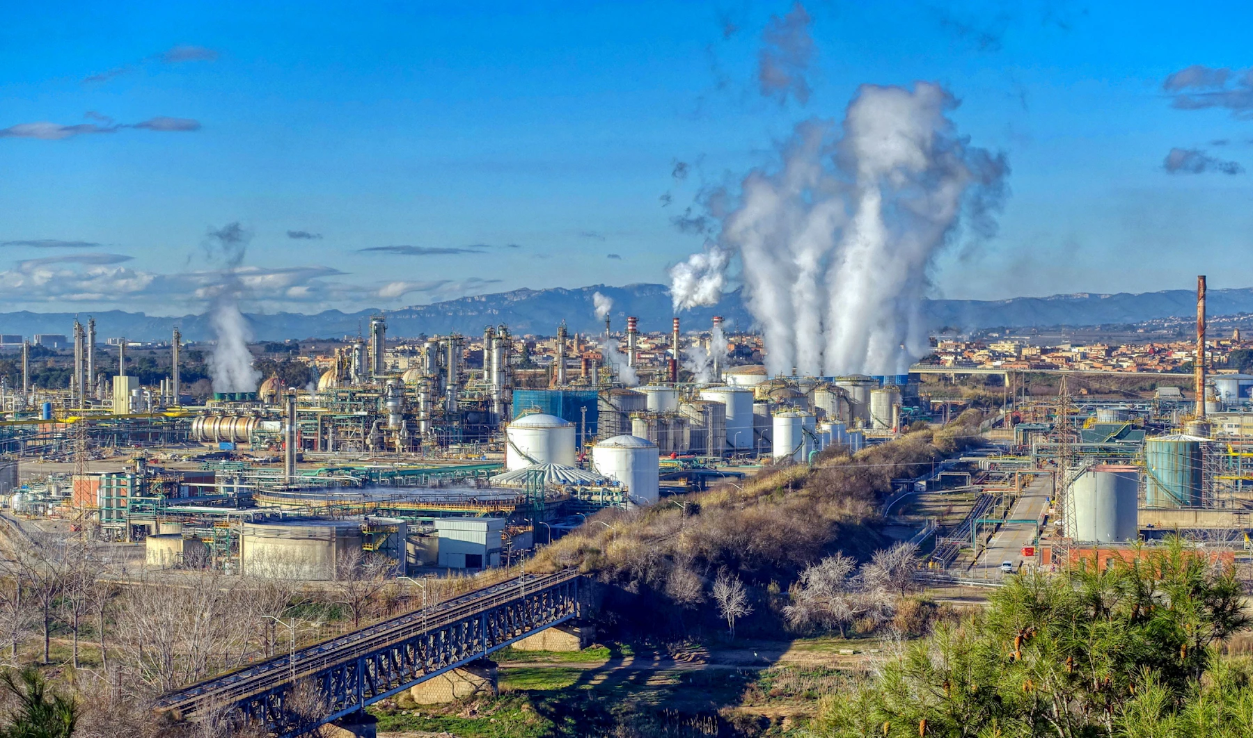 Industrial facility with steam rising from stacks