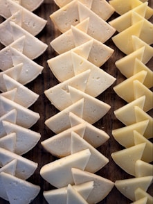 Wedge-shaped pieces of cheese arranged in rows