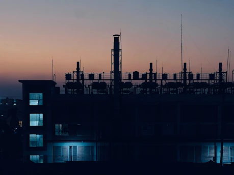 Industrial building silhouette against twilight sky