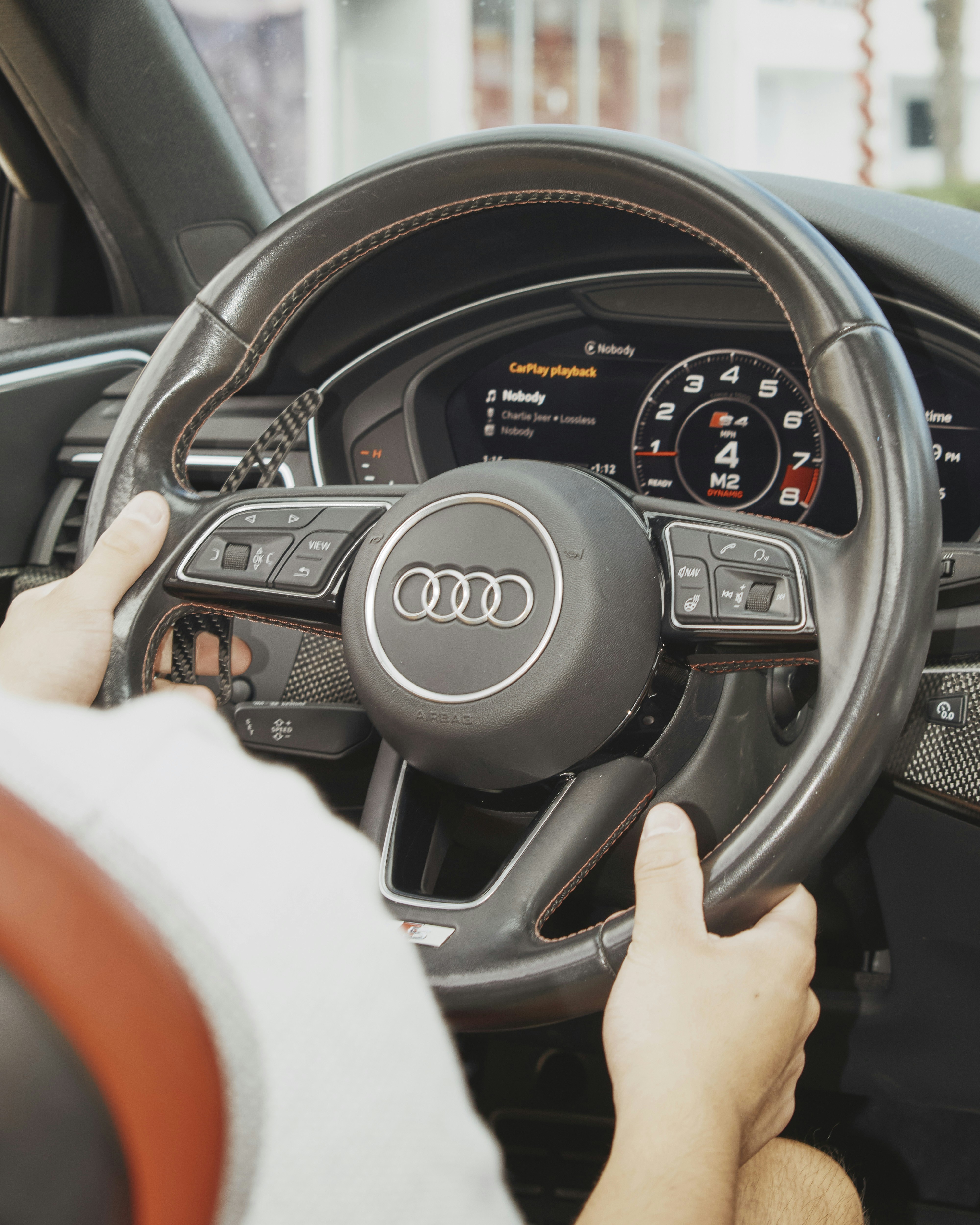 Hands on the steering wheel of a car