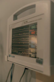 Close-up of a medical monitor displaying vital signs.