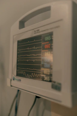 Close-up of a medical monitor displaying vital signs.