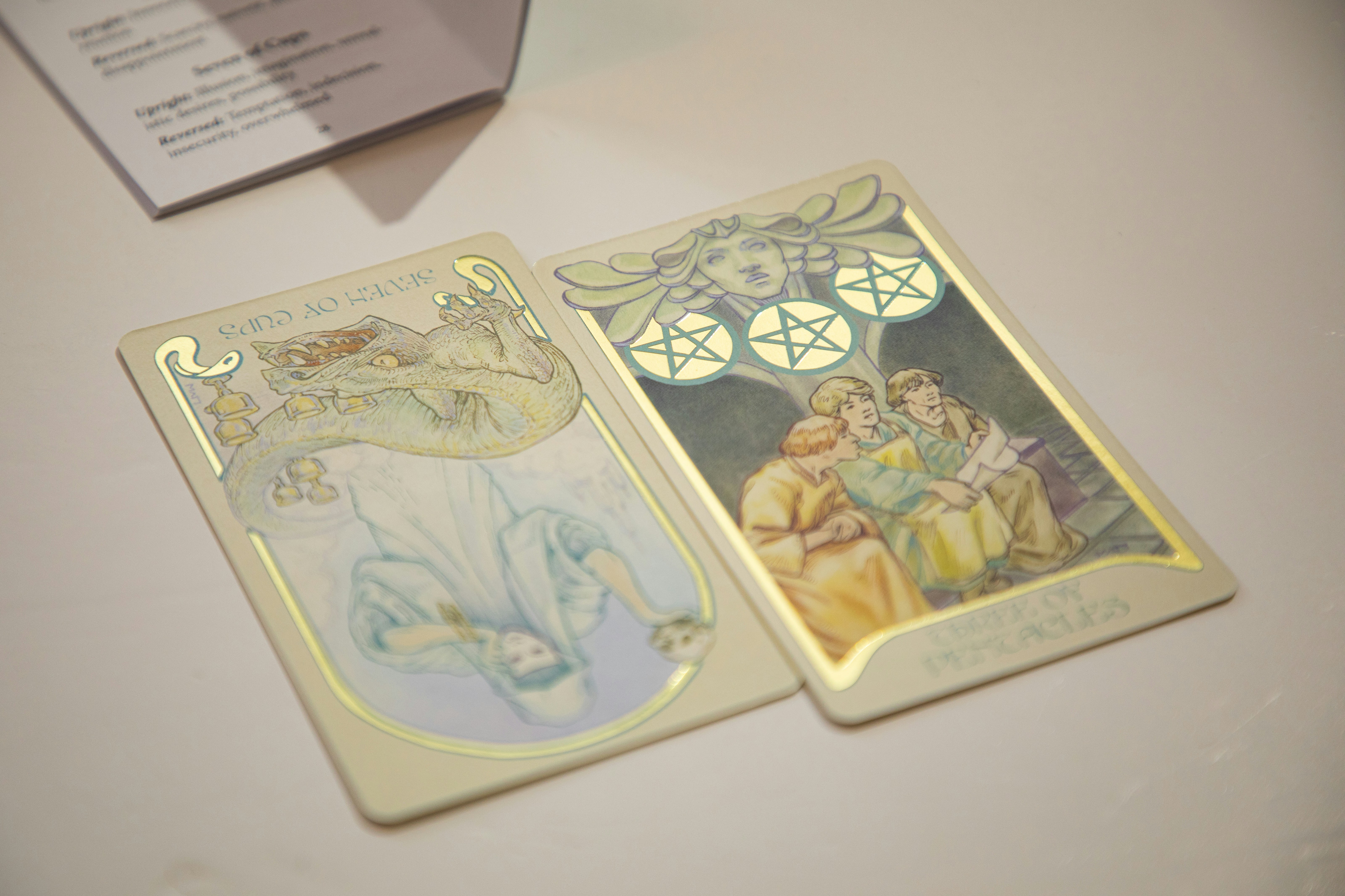 Two tarot cards displayed on a surface.