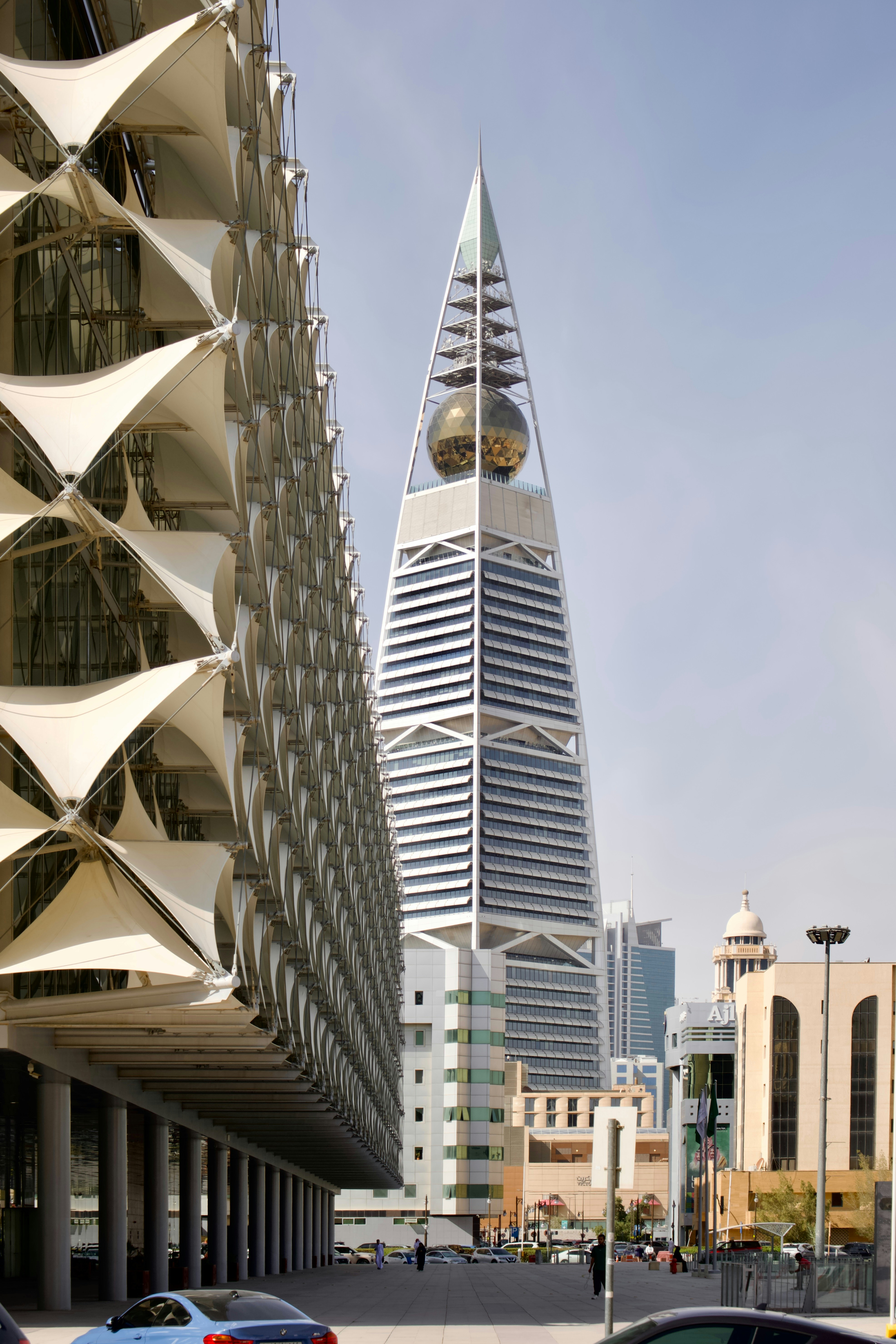 Modern architecture with a pyramid-shaped skyscraper and sphere.