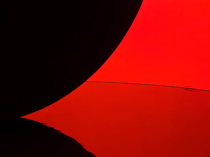 Sweeping red and black forms inside an artwork at teamLab Phenomena Abu Dhabi