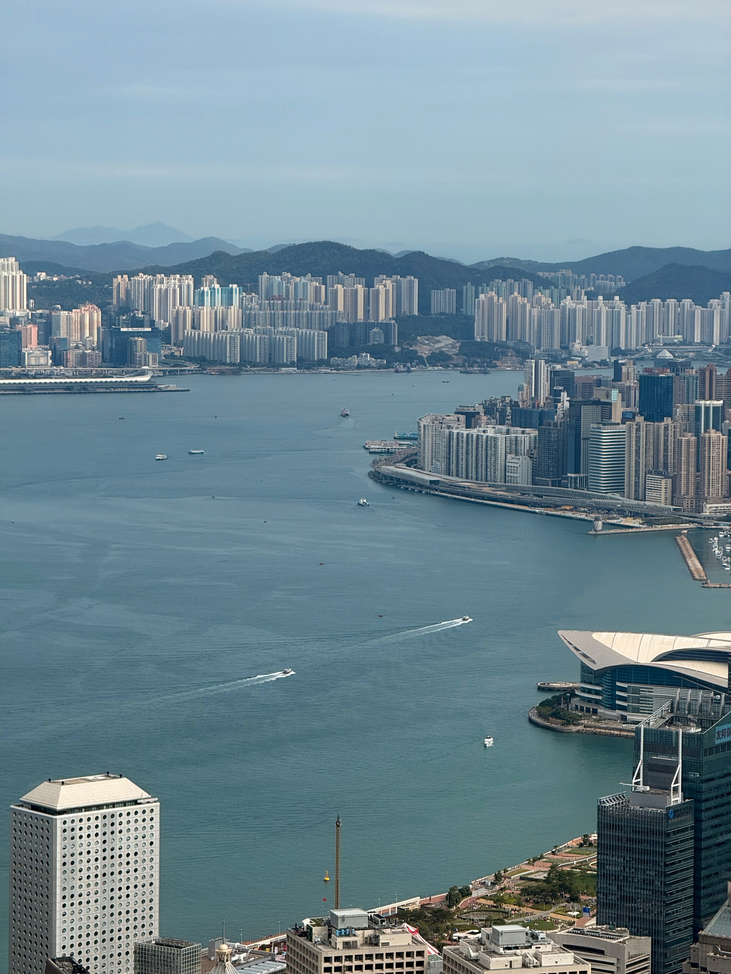 City skyline across a wide bay with boats.